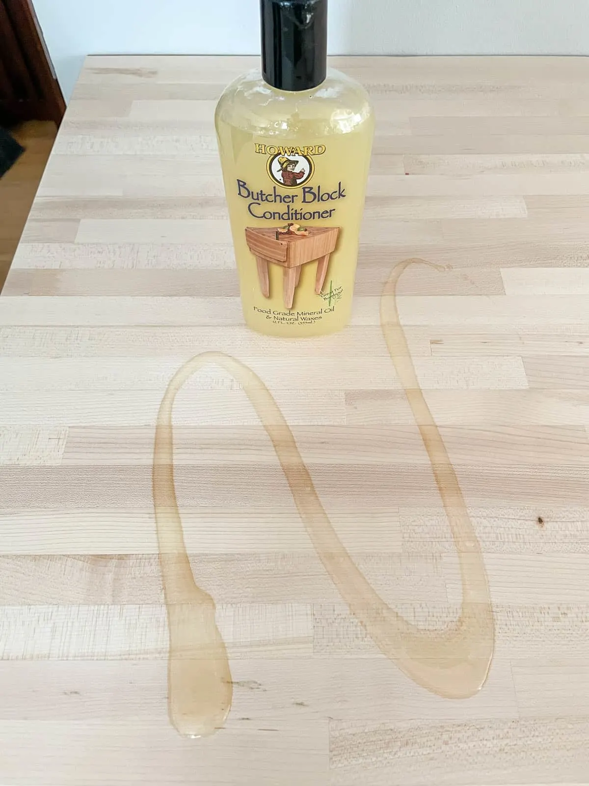 applying butcher block oil to countertop