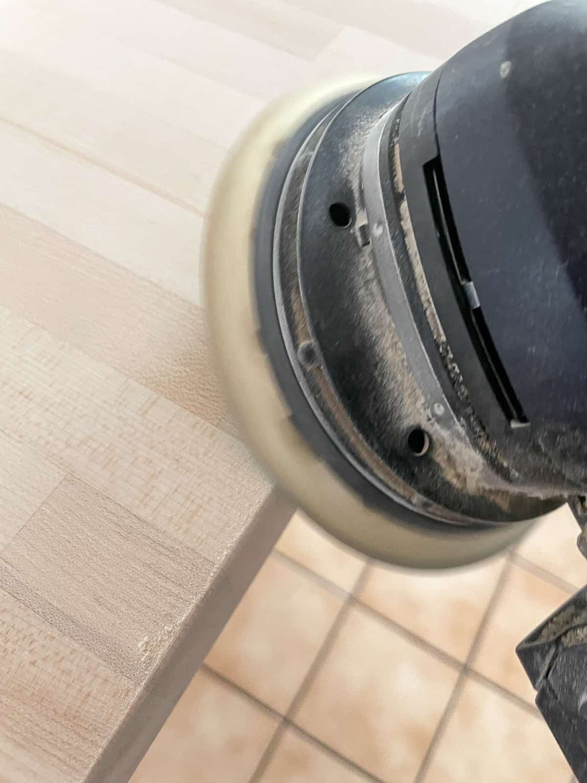 sanding cut edge of the butcher block countertop