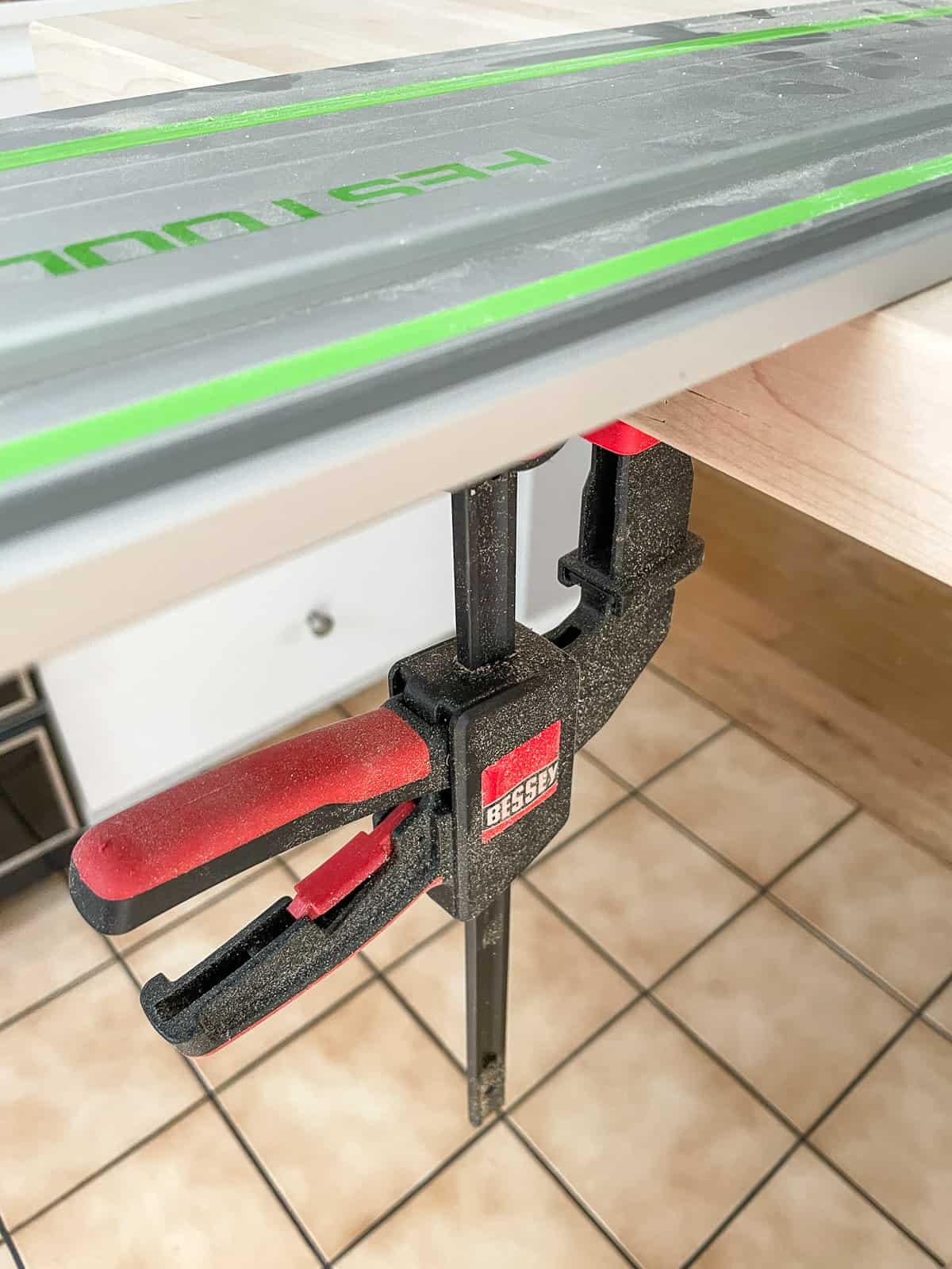 Bessey track saw clamp holding track to butcher block countertop