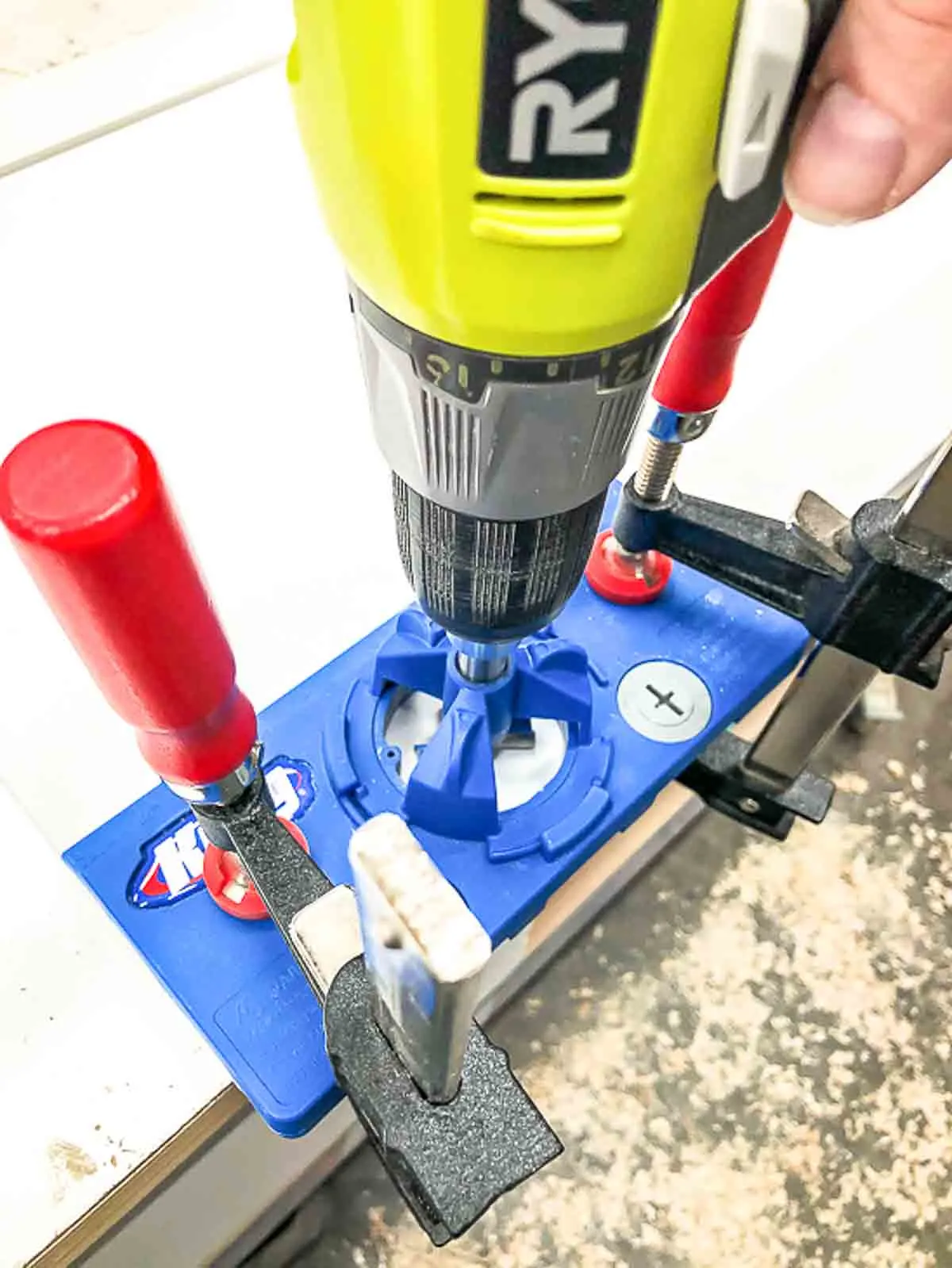 concealed hinge jig clamped to cabinet door