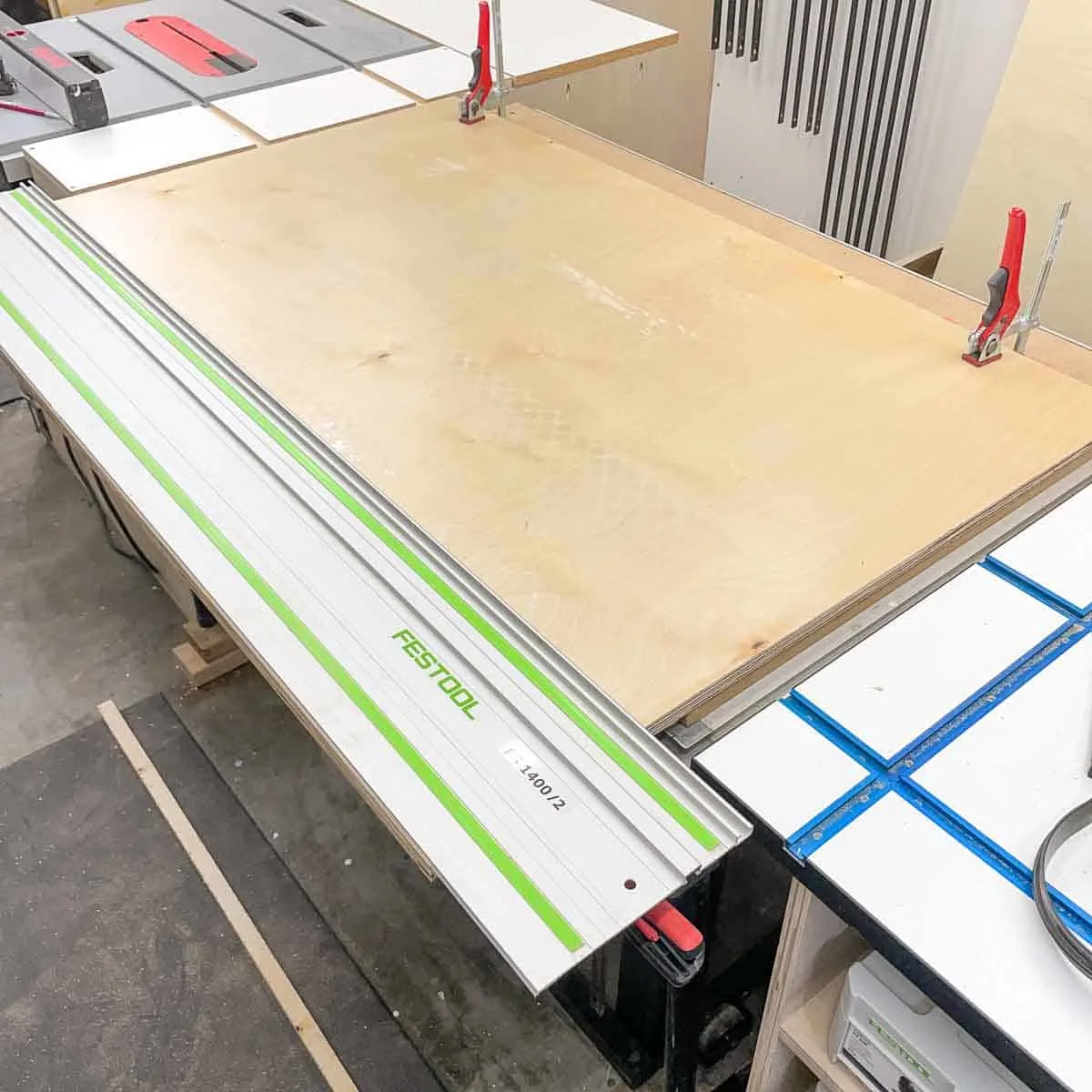 trimming plywood for wall cabinets with a track saw on a workbench
