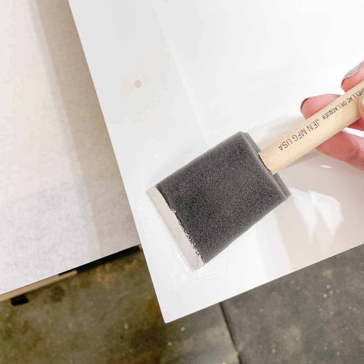 painting over old screw holes in cabinet door with a foam brush