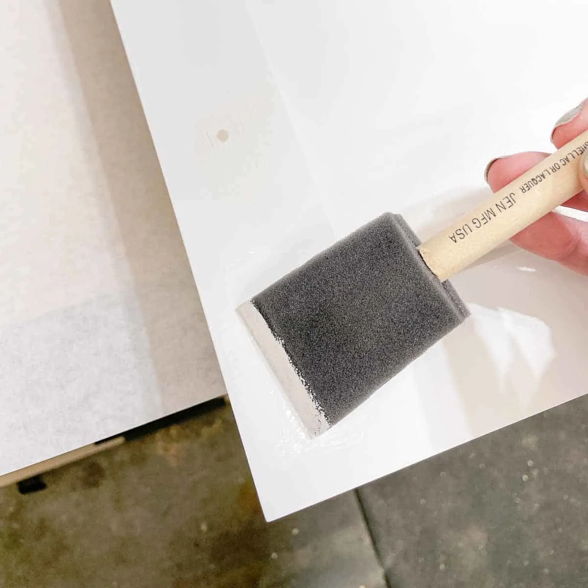 painting over old screw holes in cabinet door with a foam brush