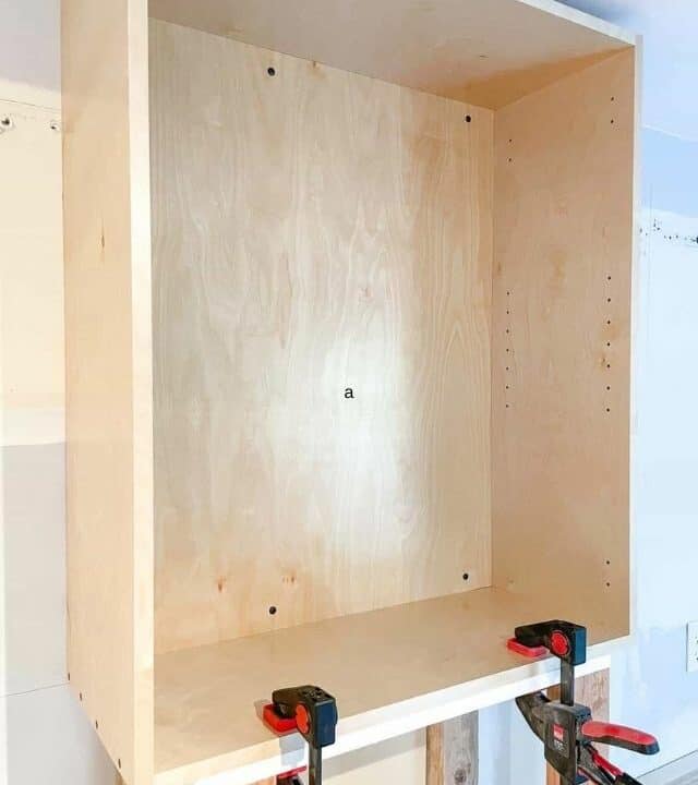wall cabinet clamped to support