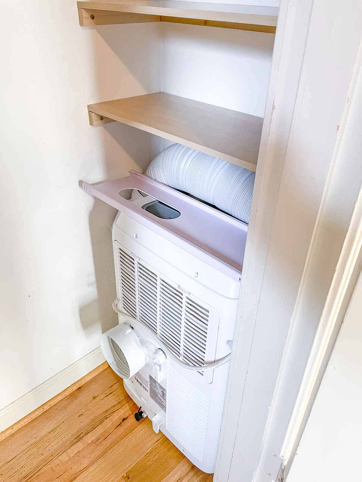 portable air conditioner with exhaust hose under DIY closet shelves
