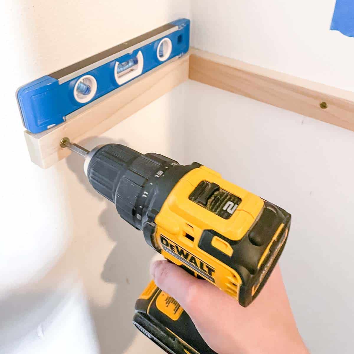 attaching the side of the DIY shelf bracket to the wall