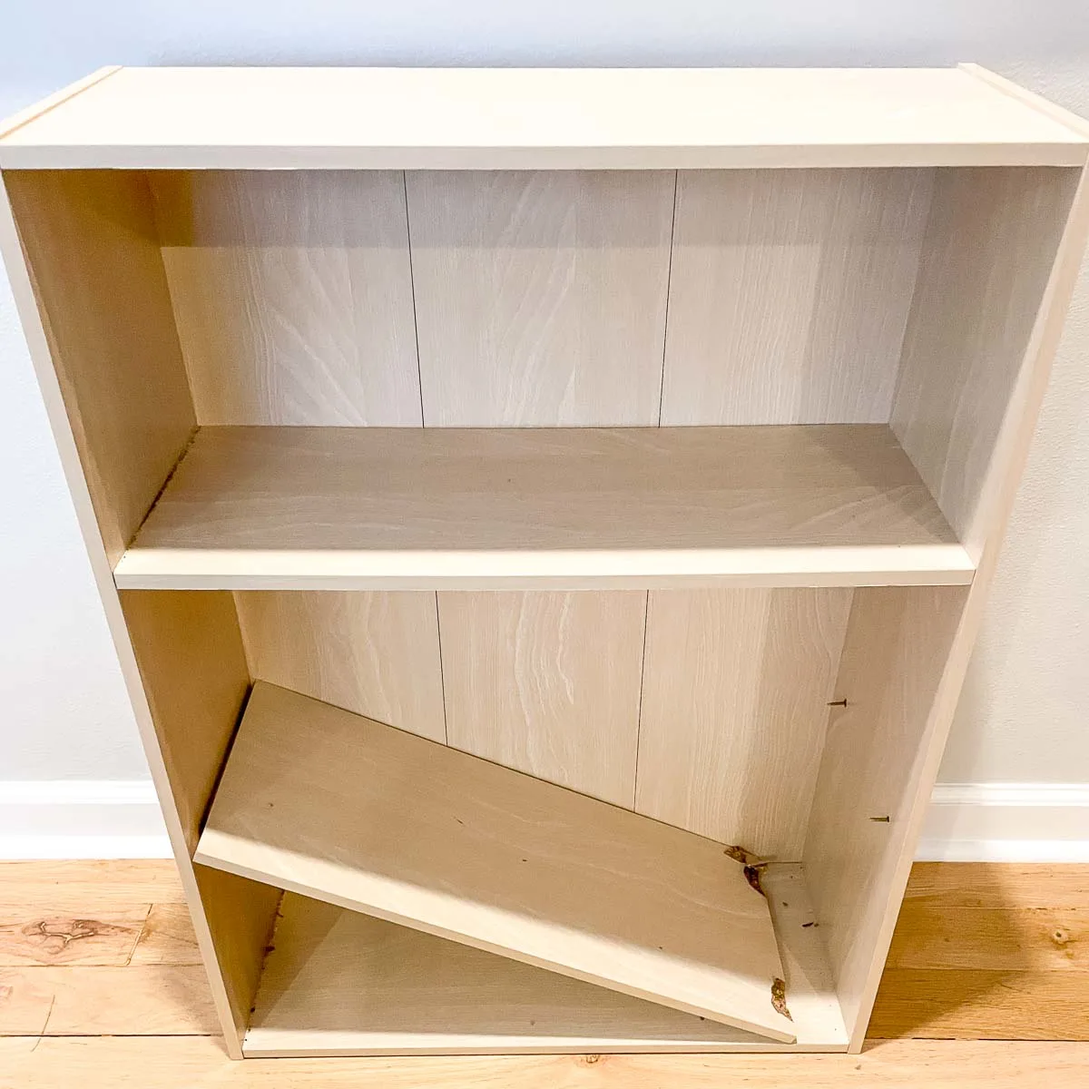 small bookcase with broken shelf