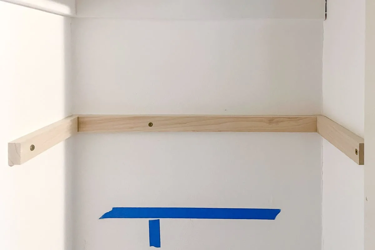 DIY shelf bracket installed on three walls of a closet