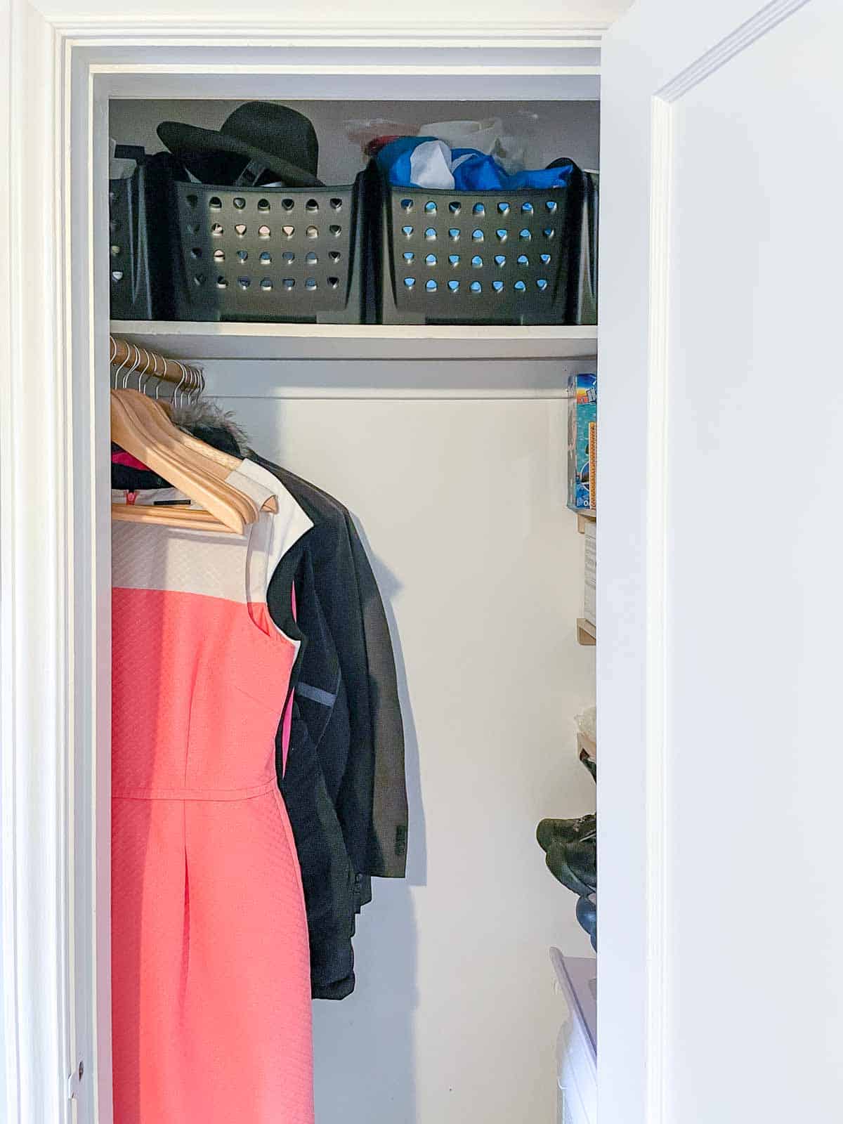 front view of organized closet with shelves on side and rod installed front to back