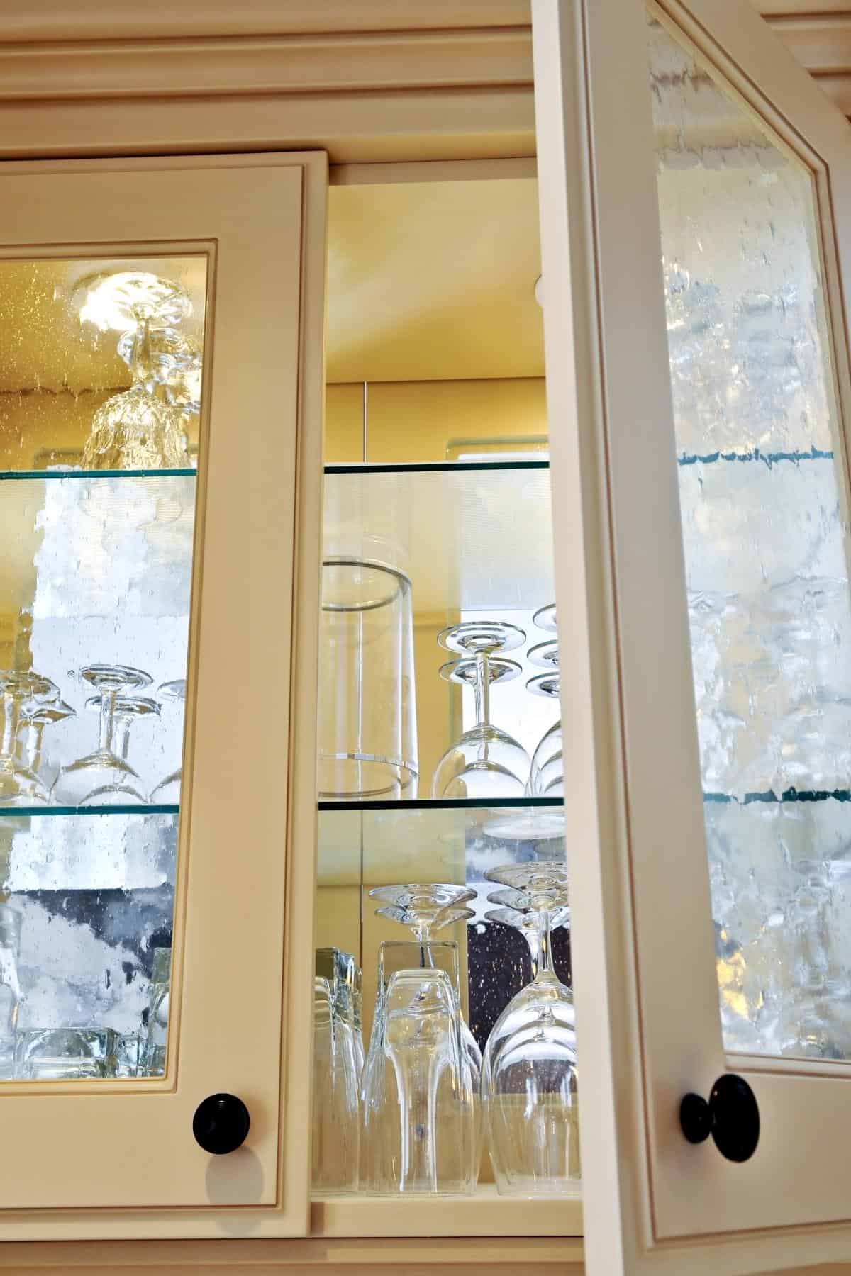 glass cabinet door displaying glassware inside