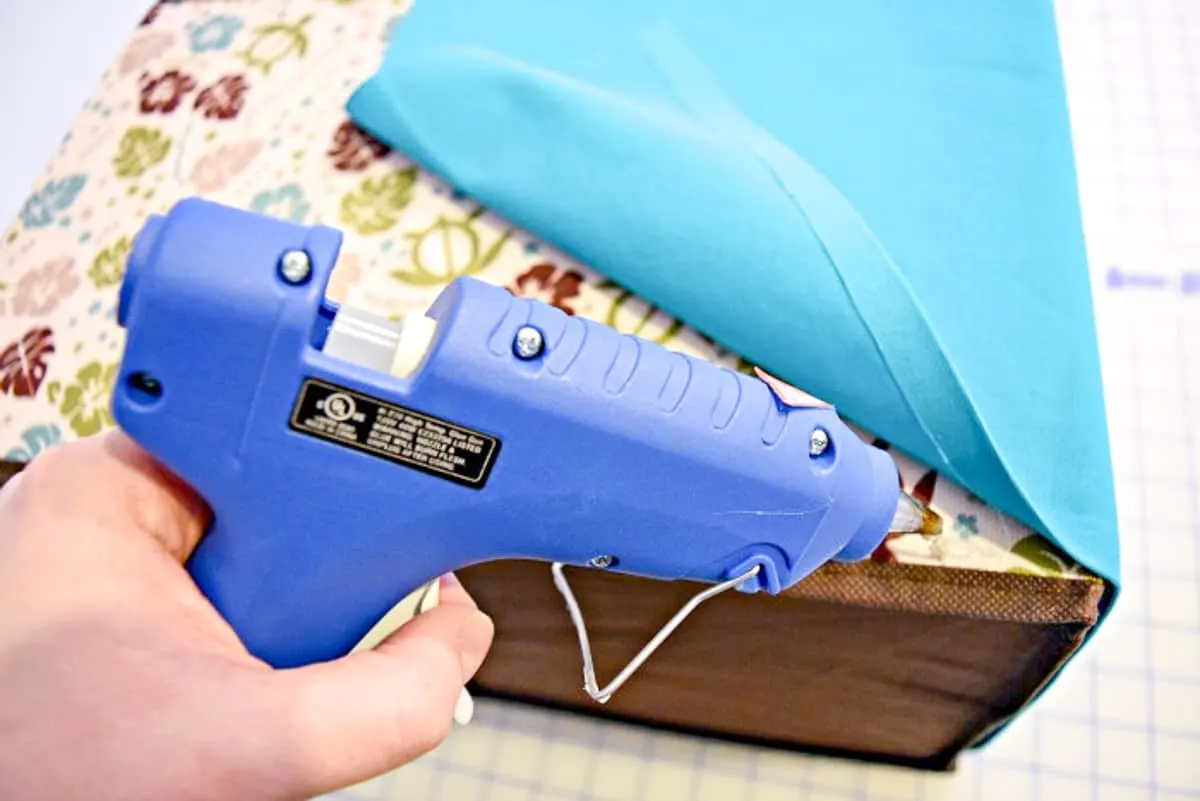 attaching fabric to a box with hot glue