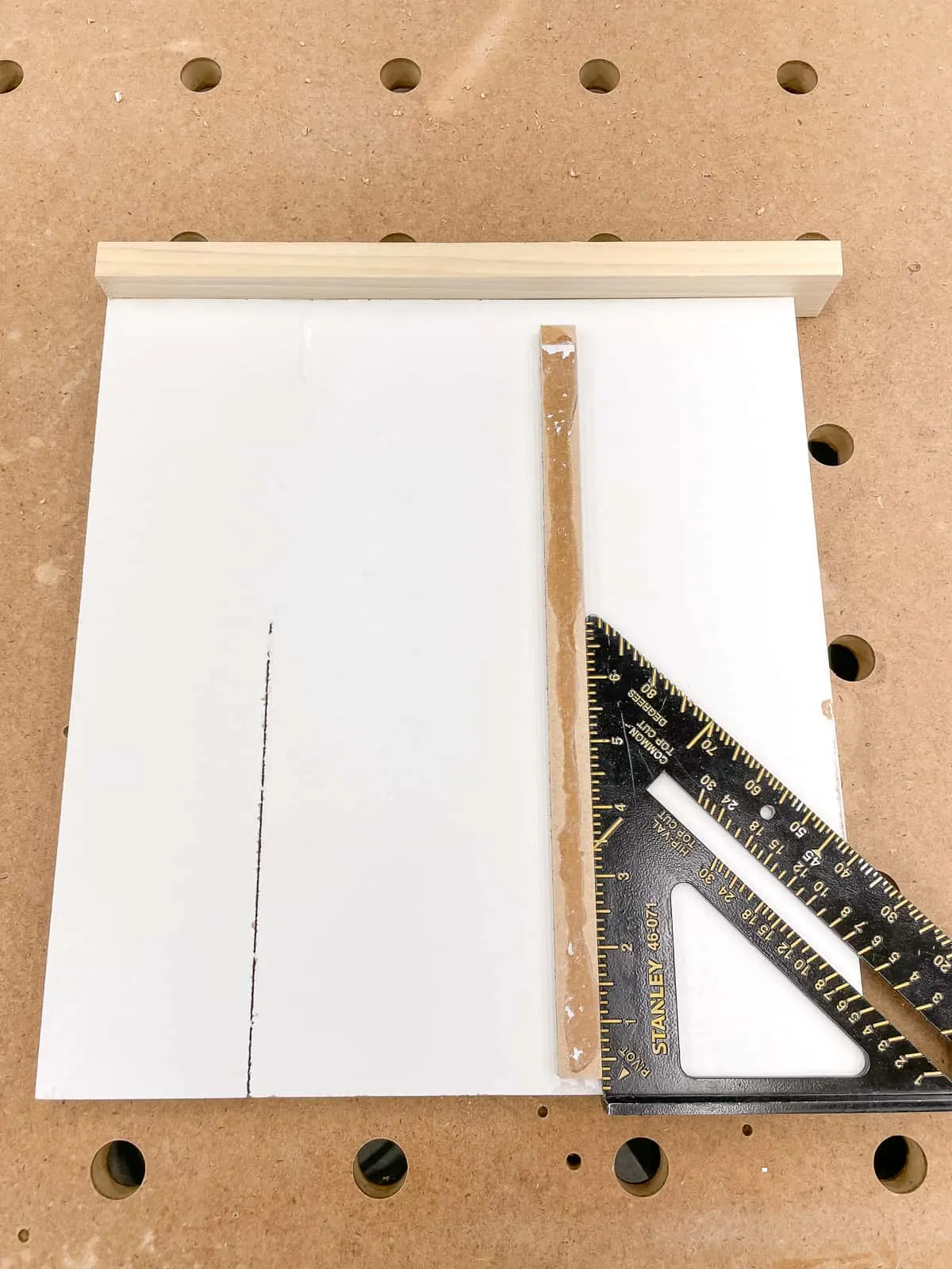 checking alignment of the runner on the bottom of the bandsaw circle jig with a square