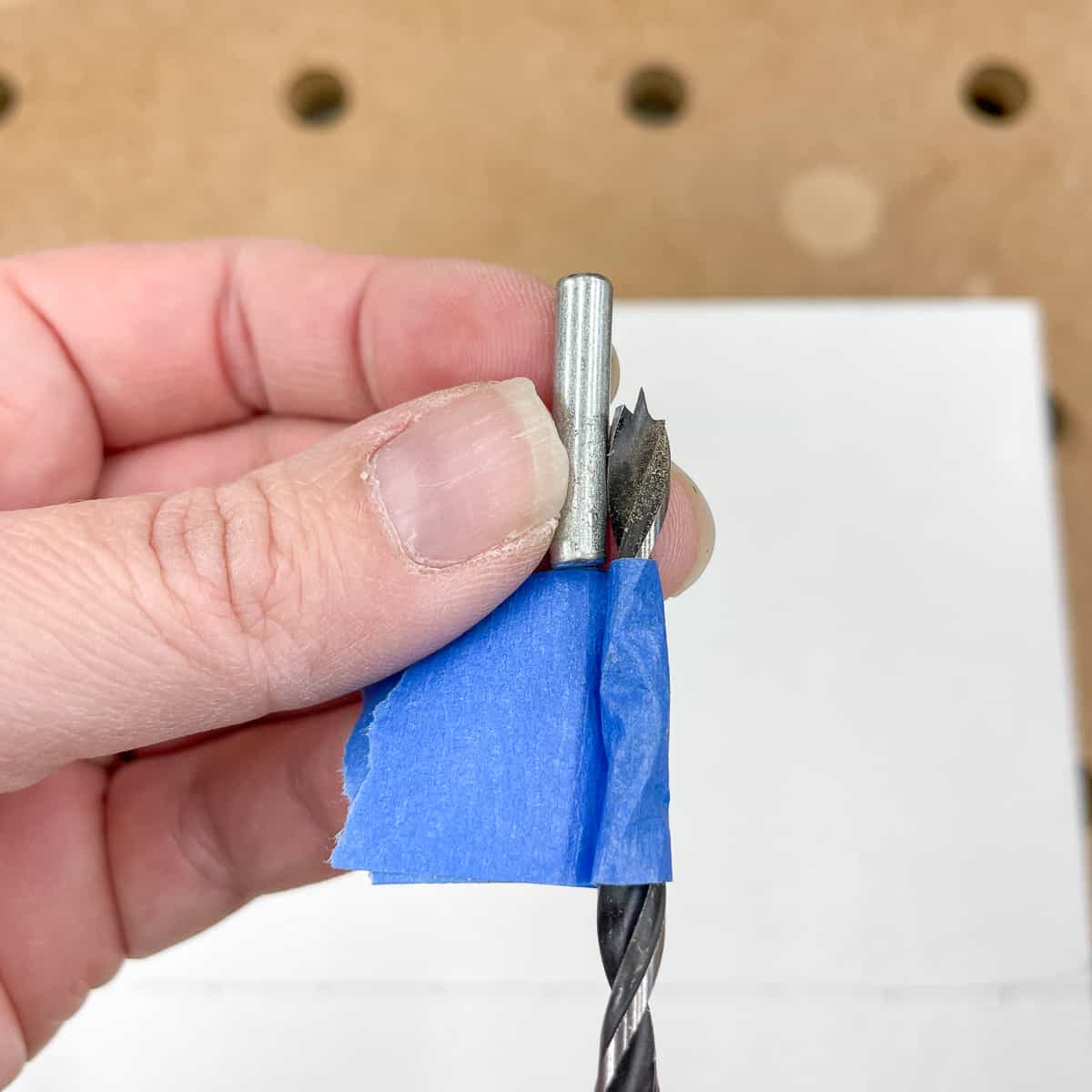 drill bit with depth marked with tape