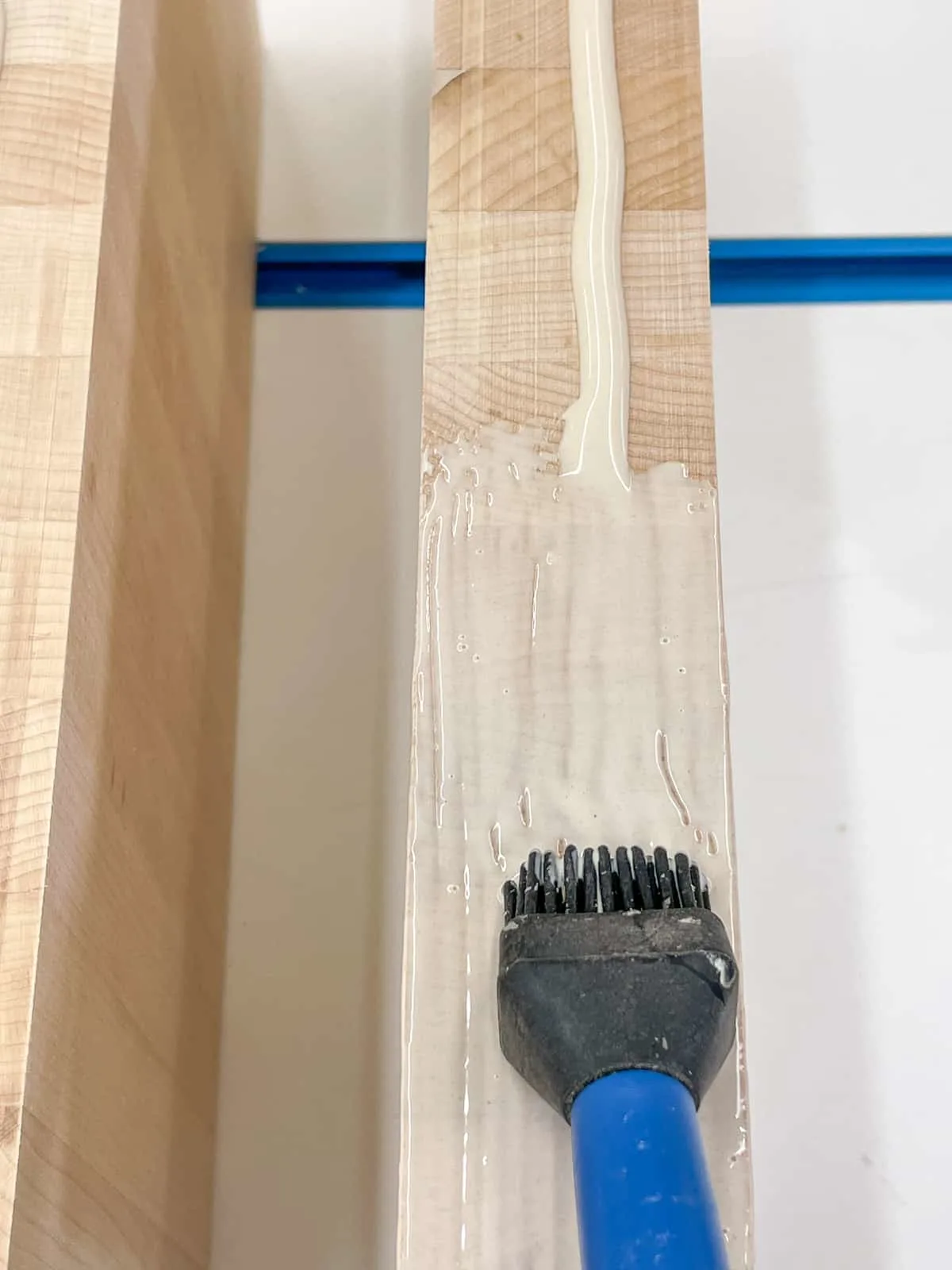 applying wood glue to edge of wood