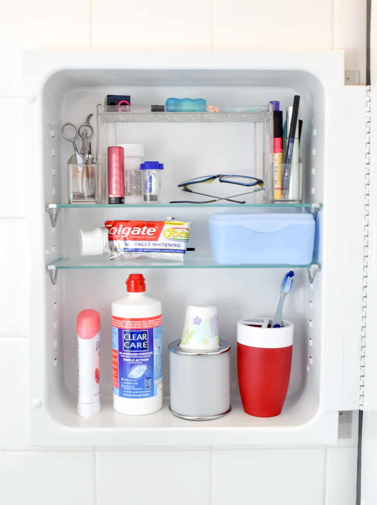 painted metal medicine cabinet with toiletries
