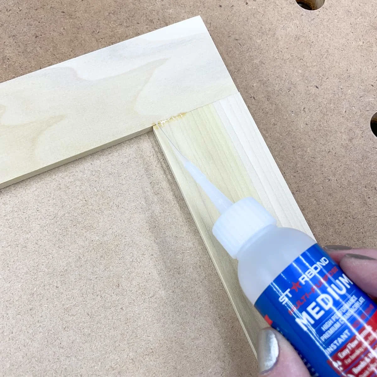 applying CA glue to gap in wood joint