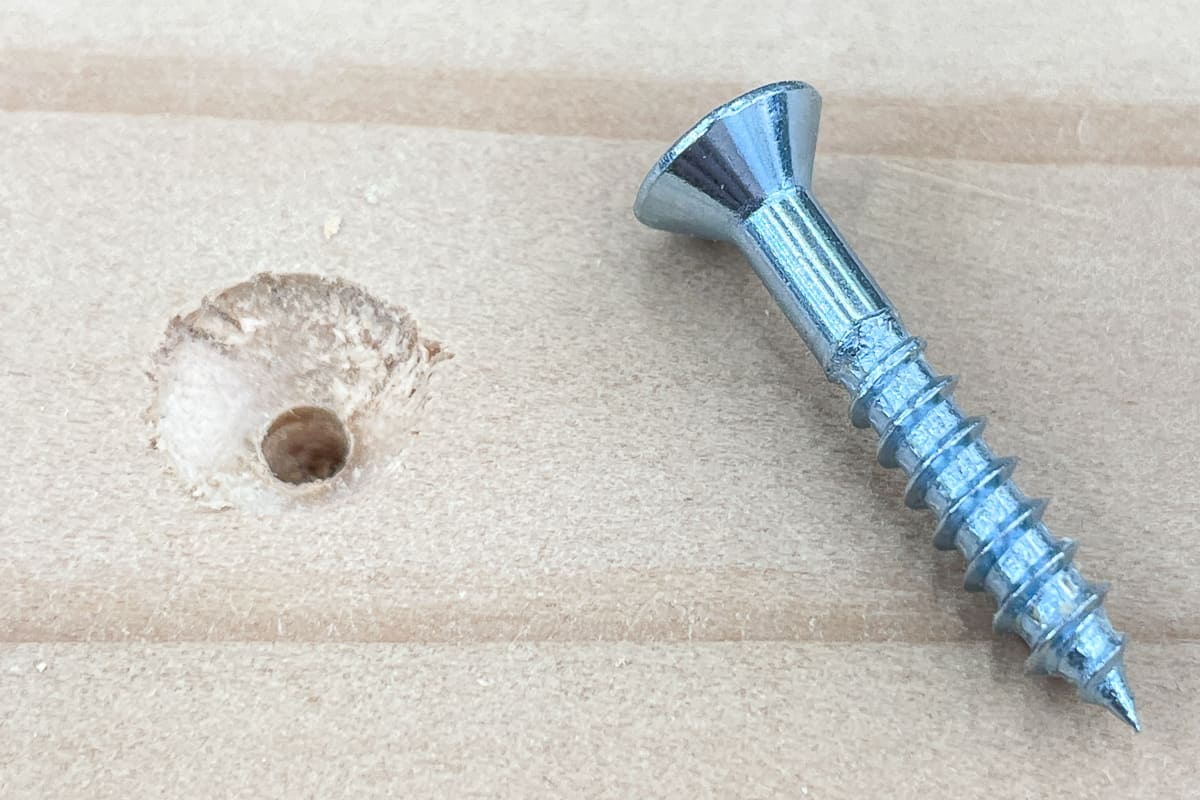 countersink hole with screw beside it