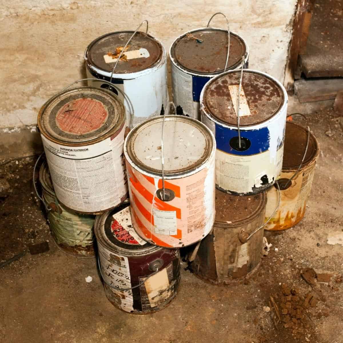 rusty old paint cans in basement