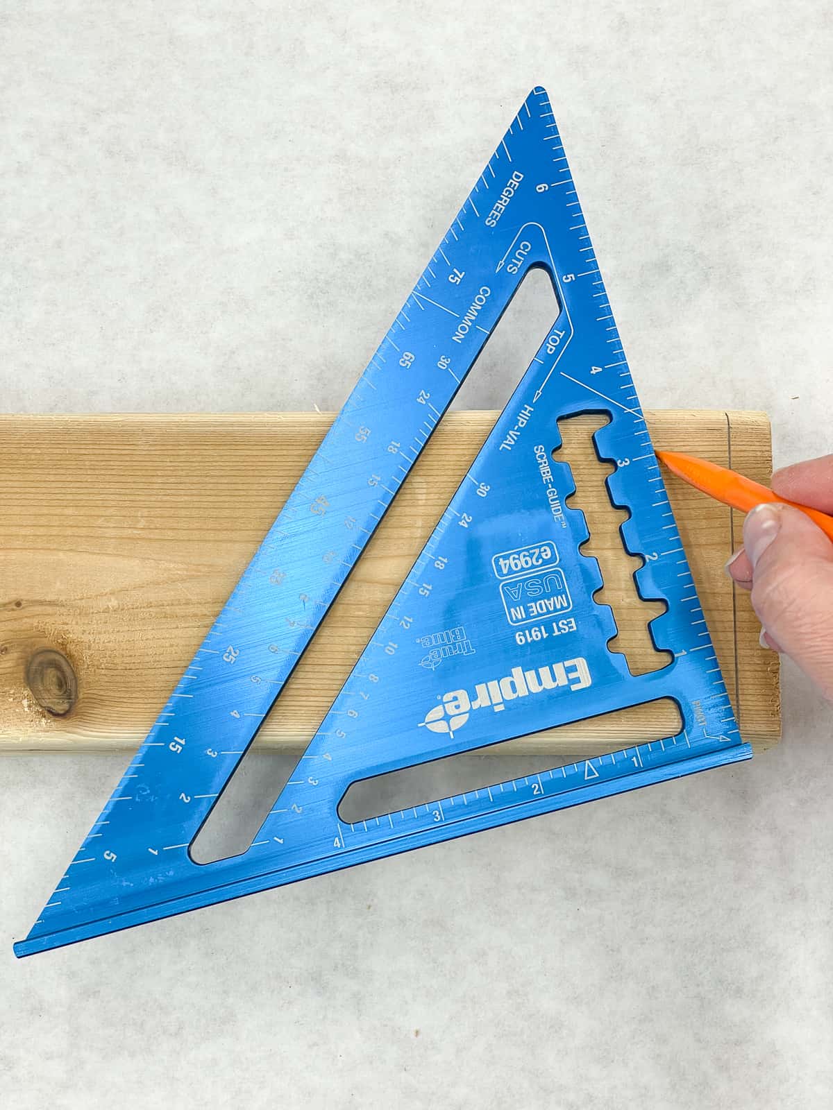 marking a 15 degree angle on a 2x4 board with a speed square