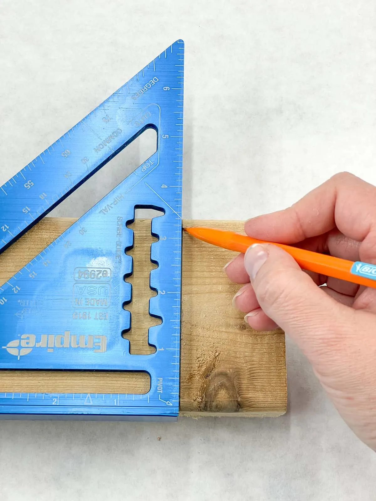 marking a straight cut at the end of a board with a speed square