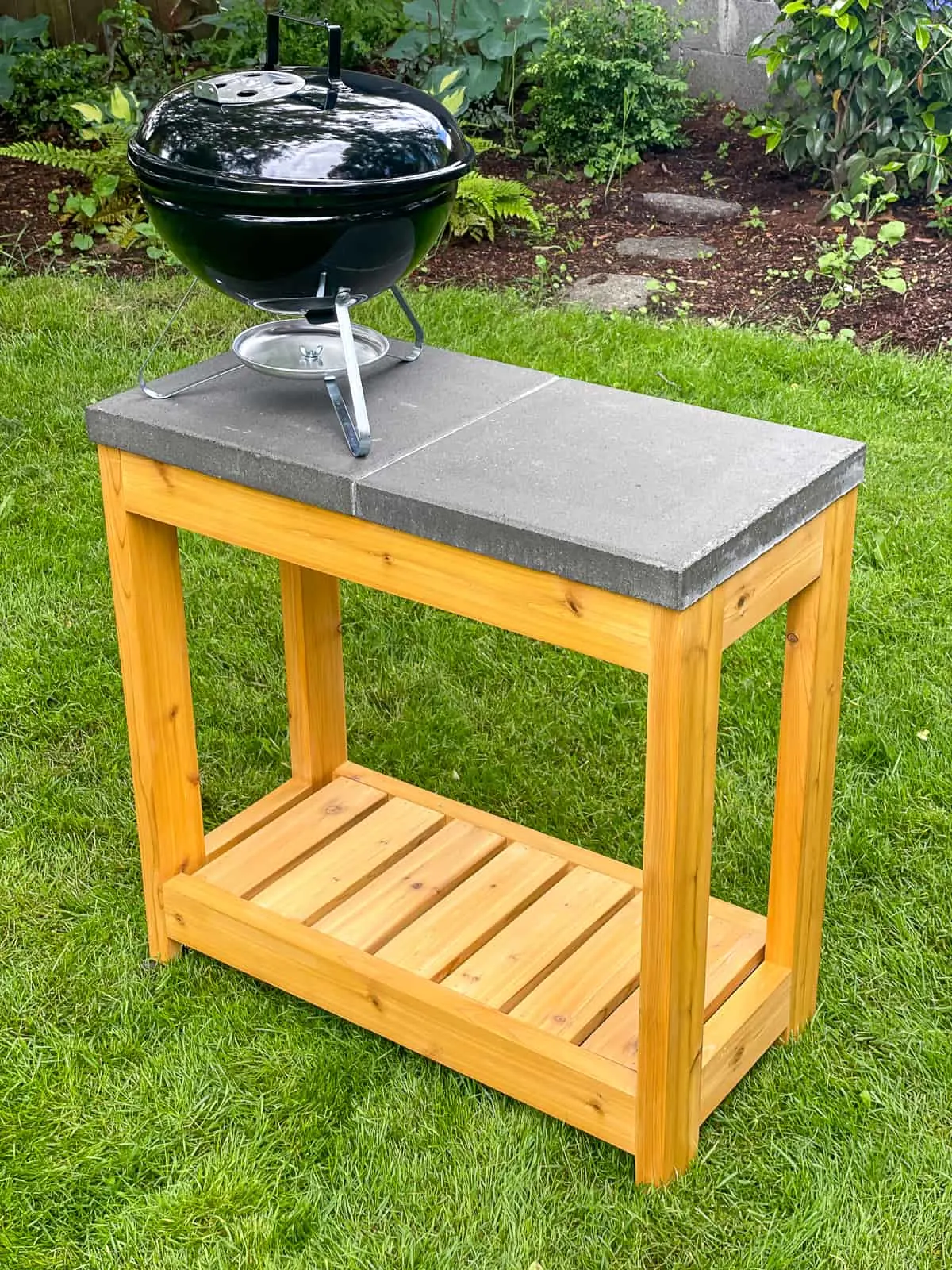 small charcoal grill on top of DIY grill station