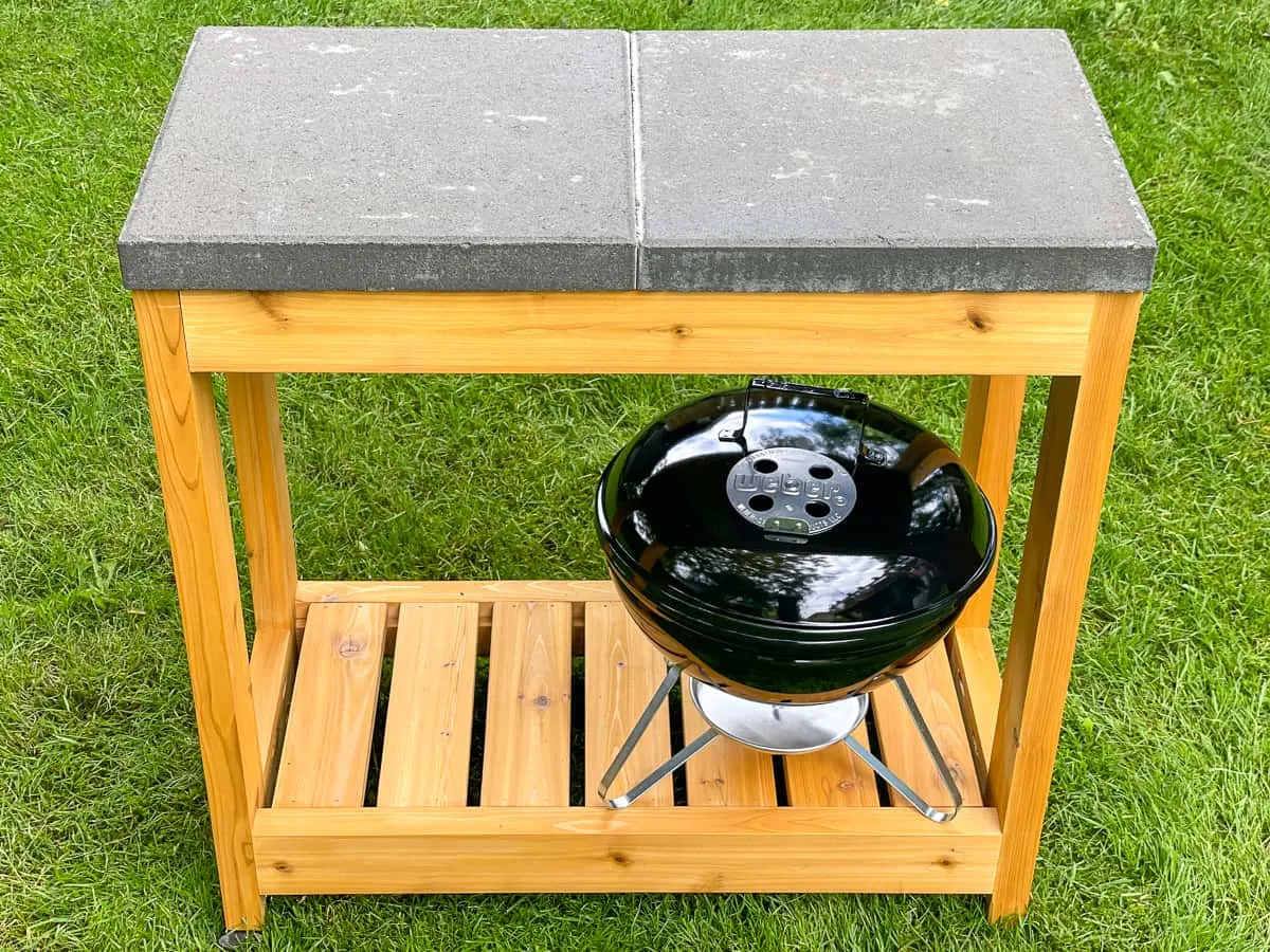 DIY grill station with tabletop grill stored on shelf below