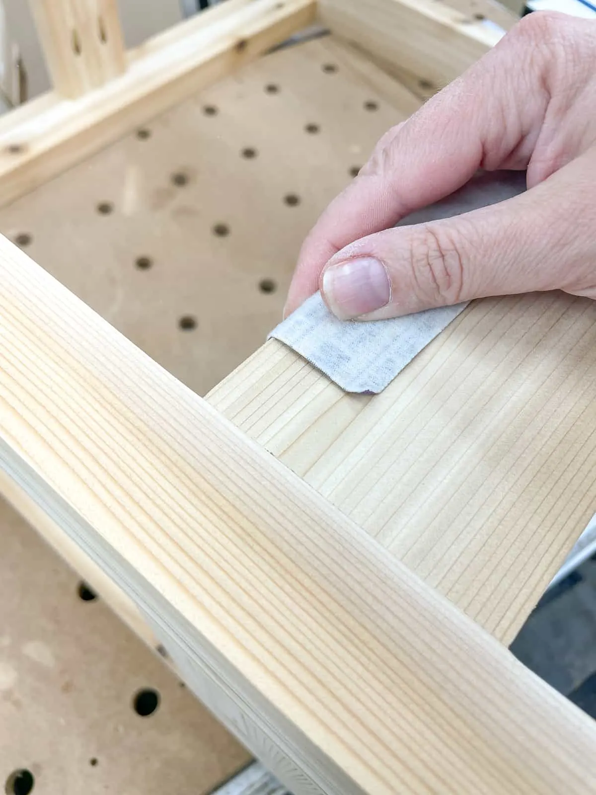 sanding over the sharp corners of the DIY grill station