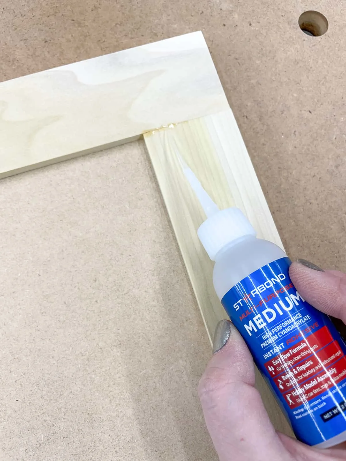 applying CA glue to joint in DIY cabinet door