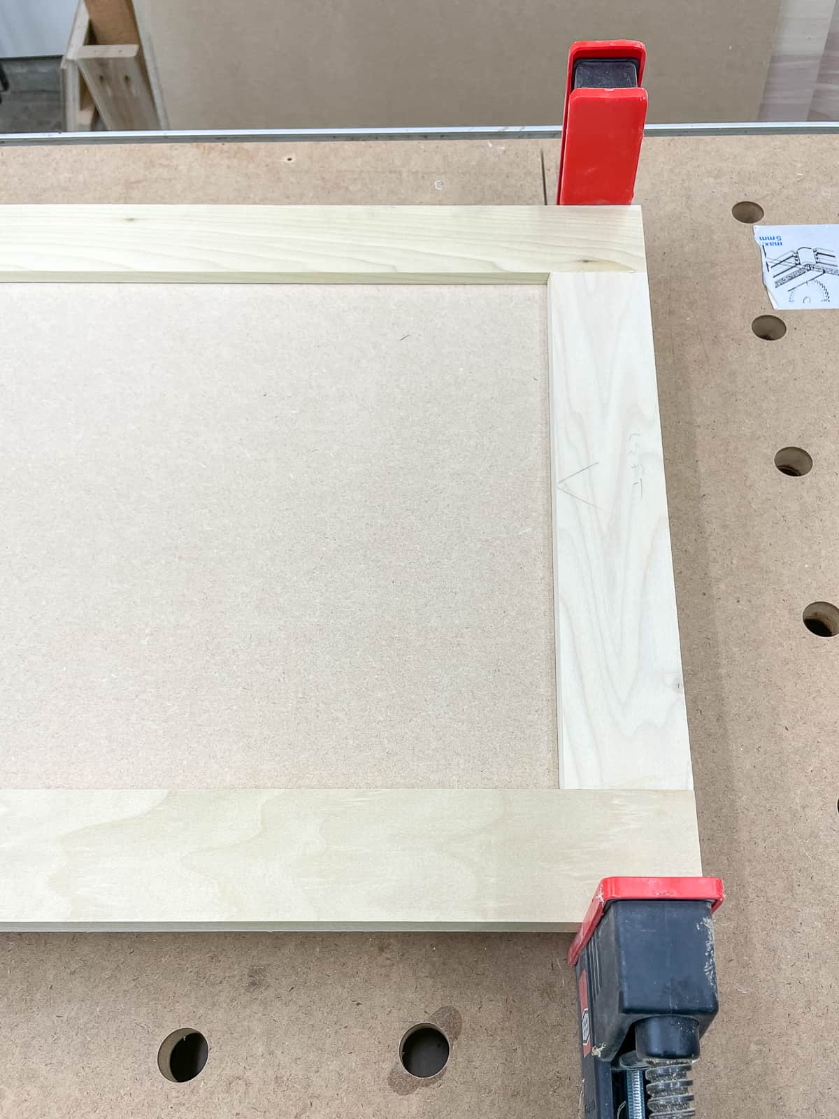 DIY cabinet door in clamps after applying wood glue