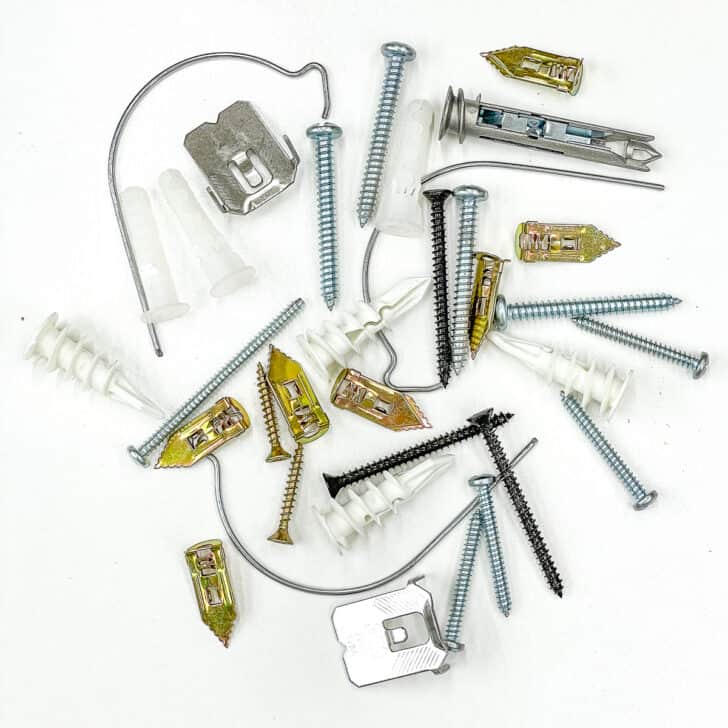 a variety of hollow wall anchors on a white background
