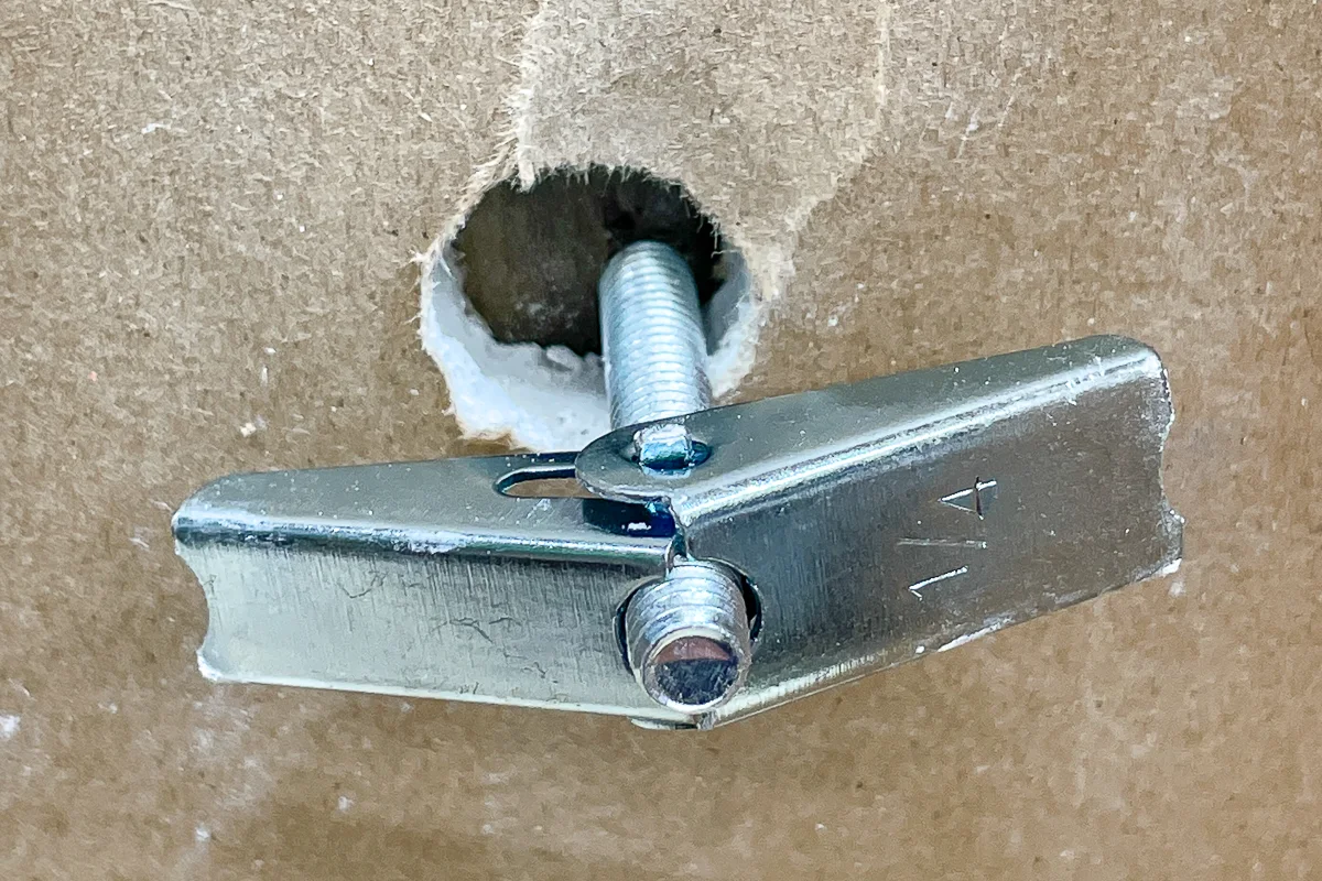 butterfly nut of toggle bolt spinning because it's not tight against the drywall