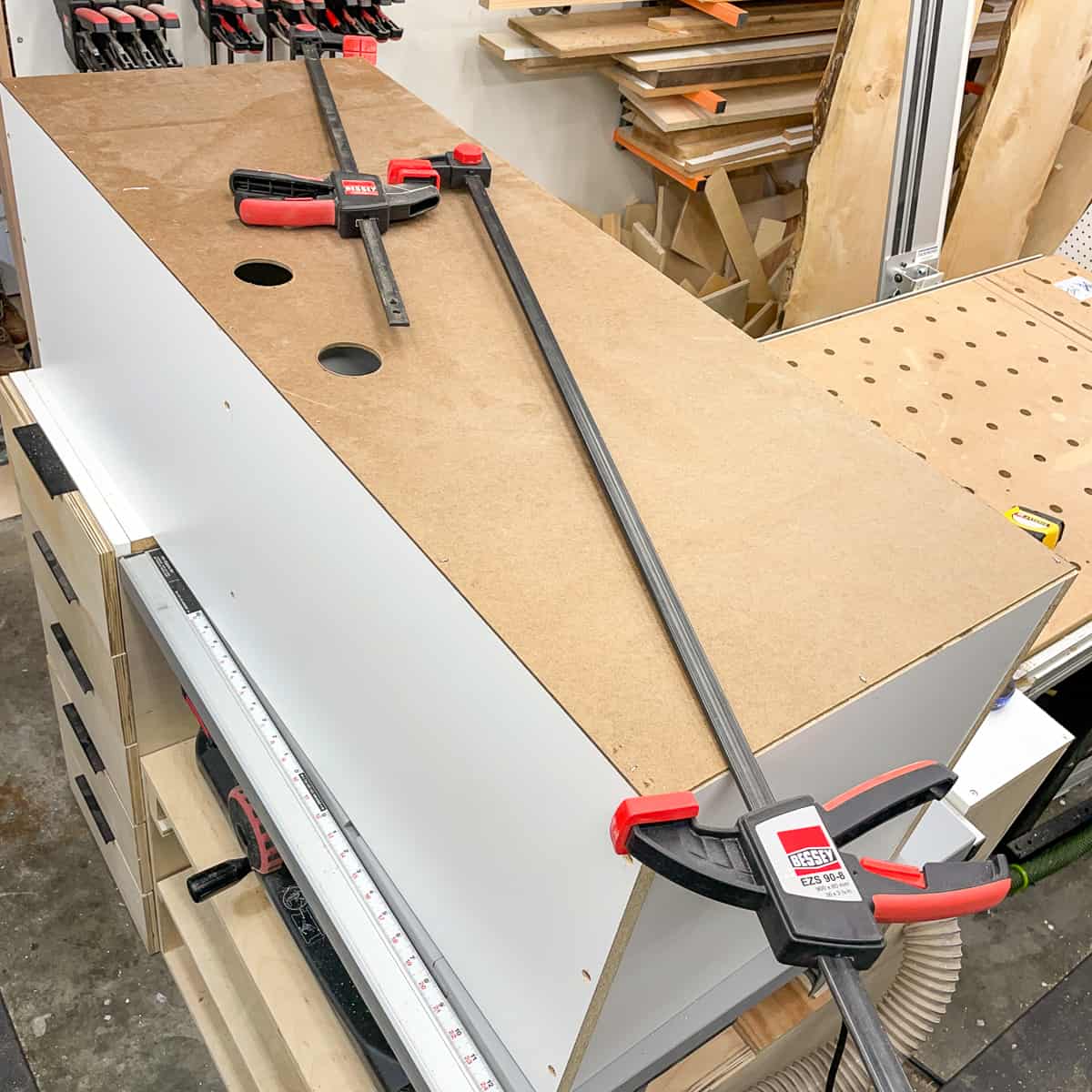 two clamps across the diagonal of the shelf box to force it square while attaching the back panel