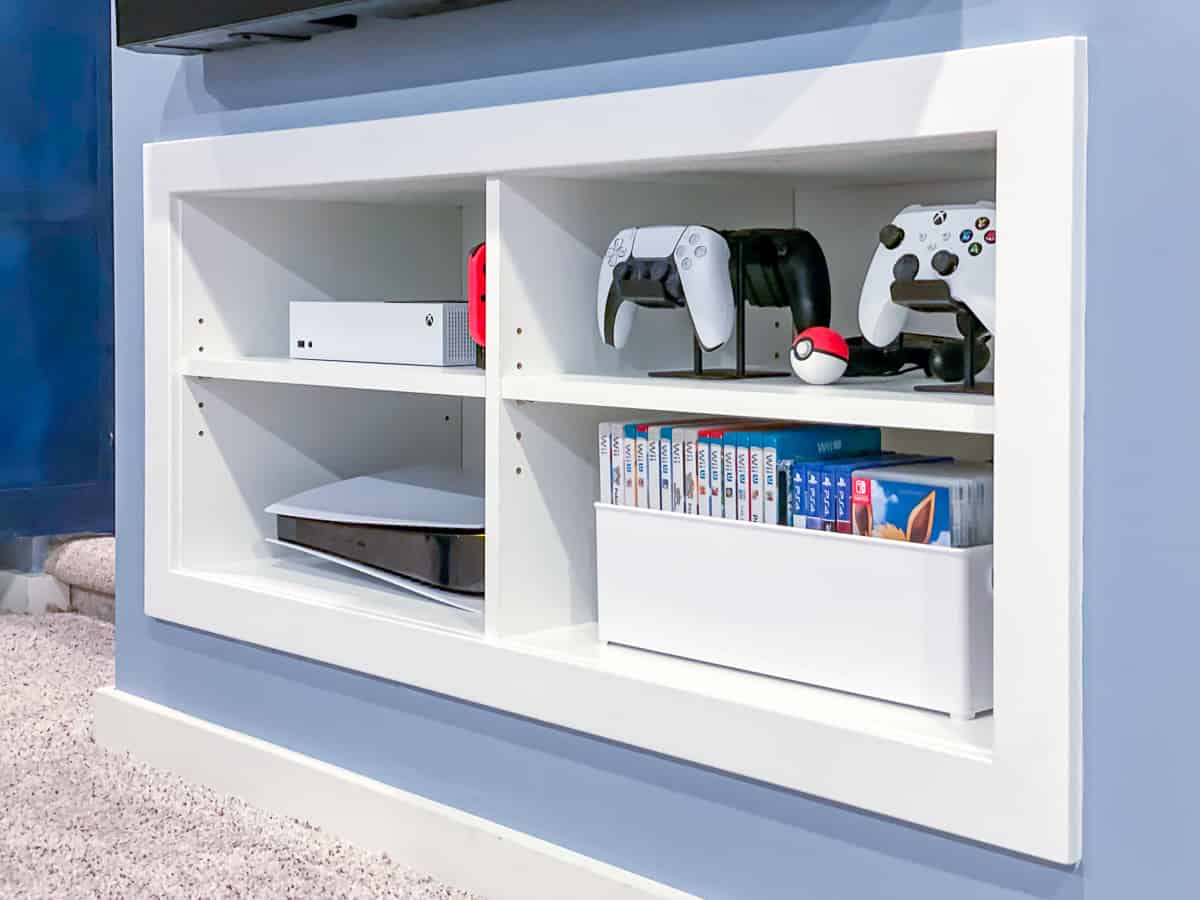 side view of game console shelves with controllers on hangers
