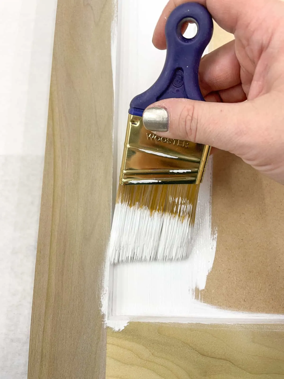 applying primer to DIY cabinet door