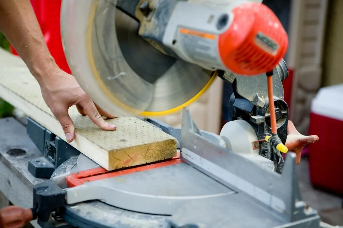 non-sliding miter saw cutting a 2x6 pressure treated board