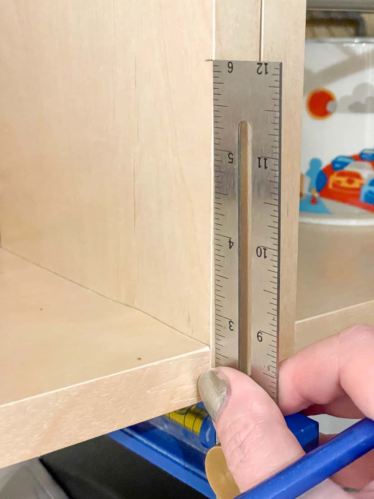 marking height for cabinet hinge mounting plate on front edge of cabinet