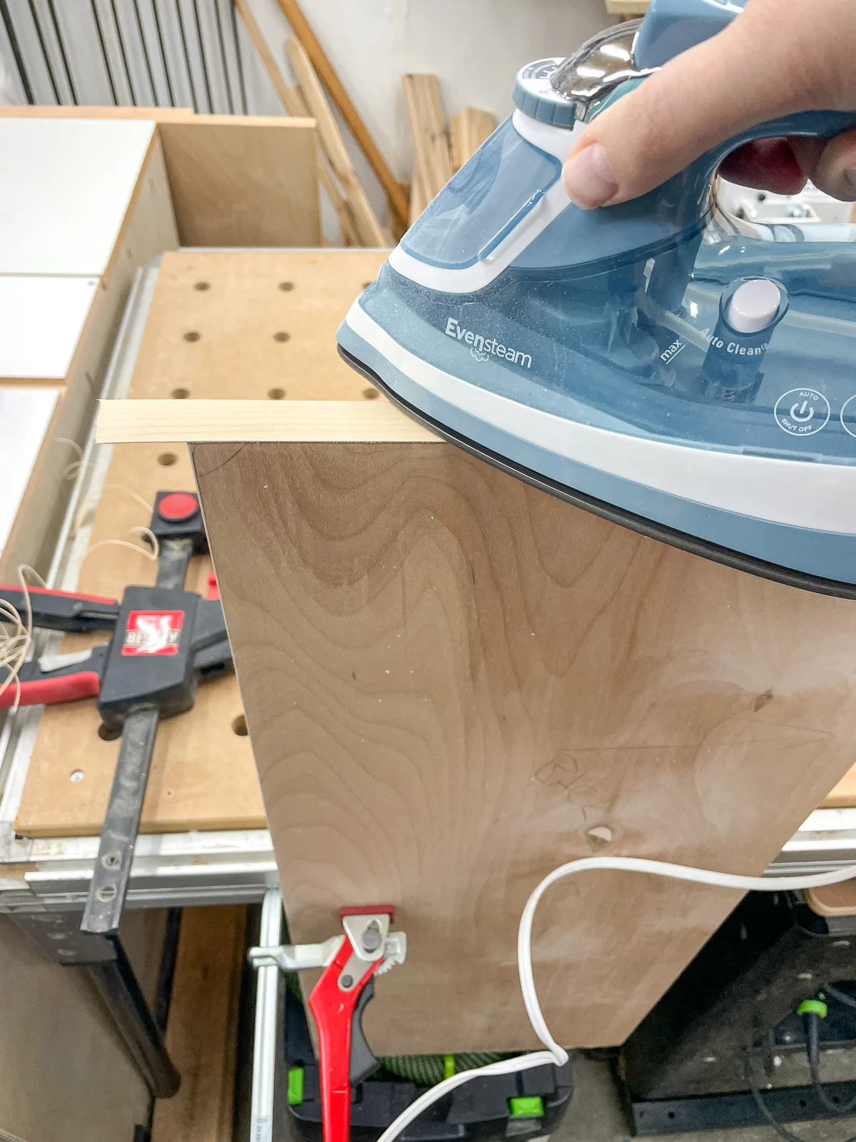 ironing on edge banding on bottom of cabinet end panel