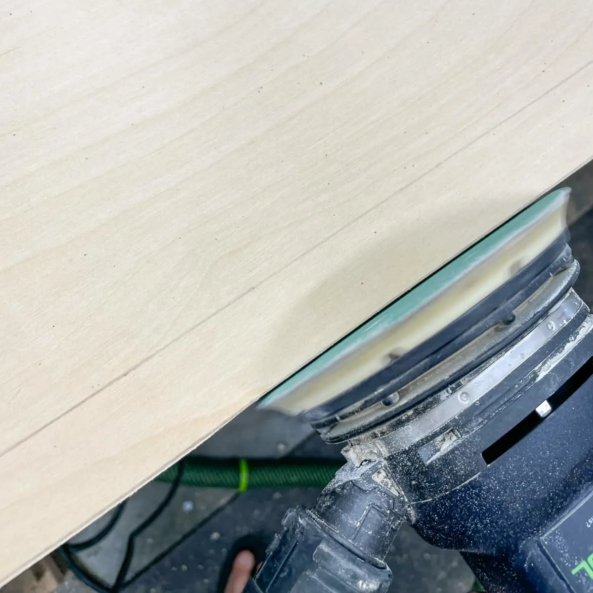 sanding up to the scribe line on a cabinet end panel
