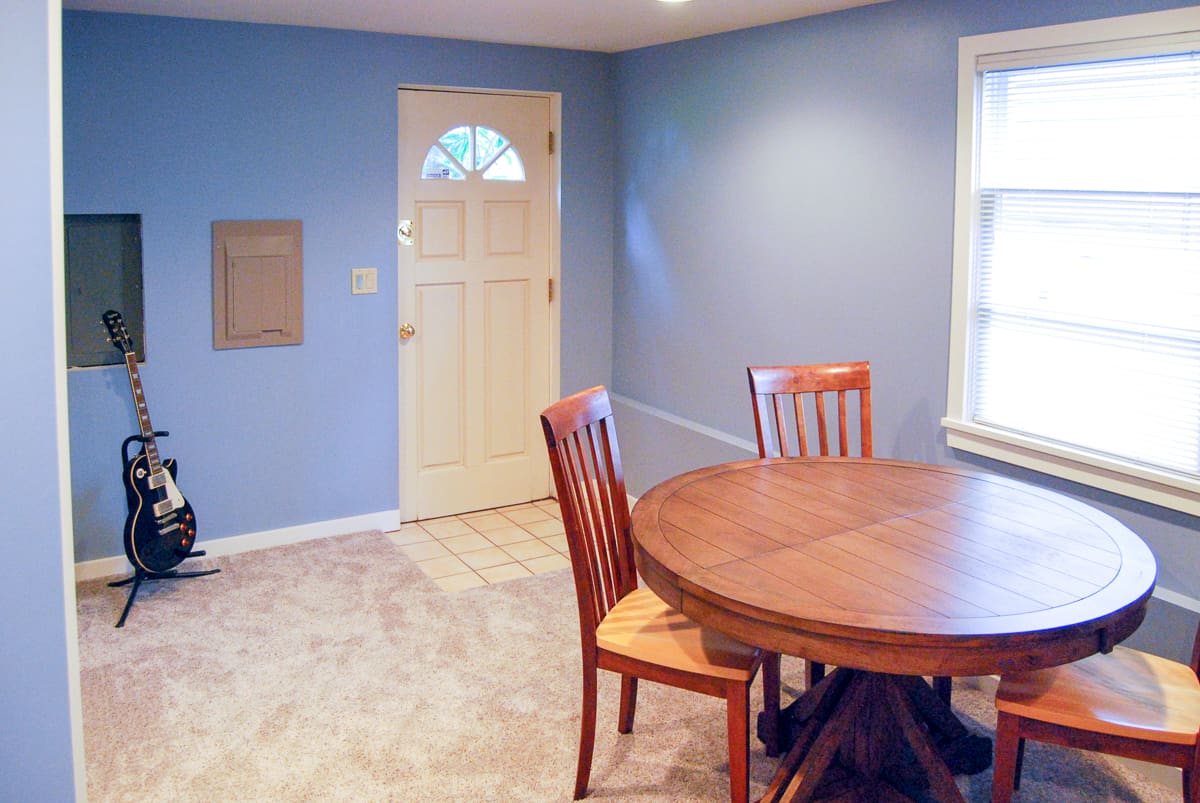 basement family room with table and chairs and carpet over tile floor