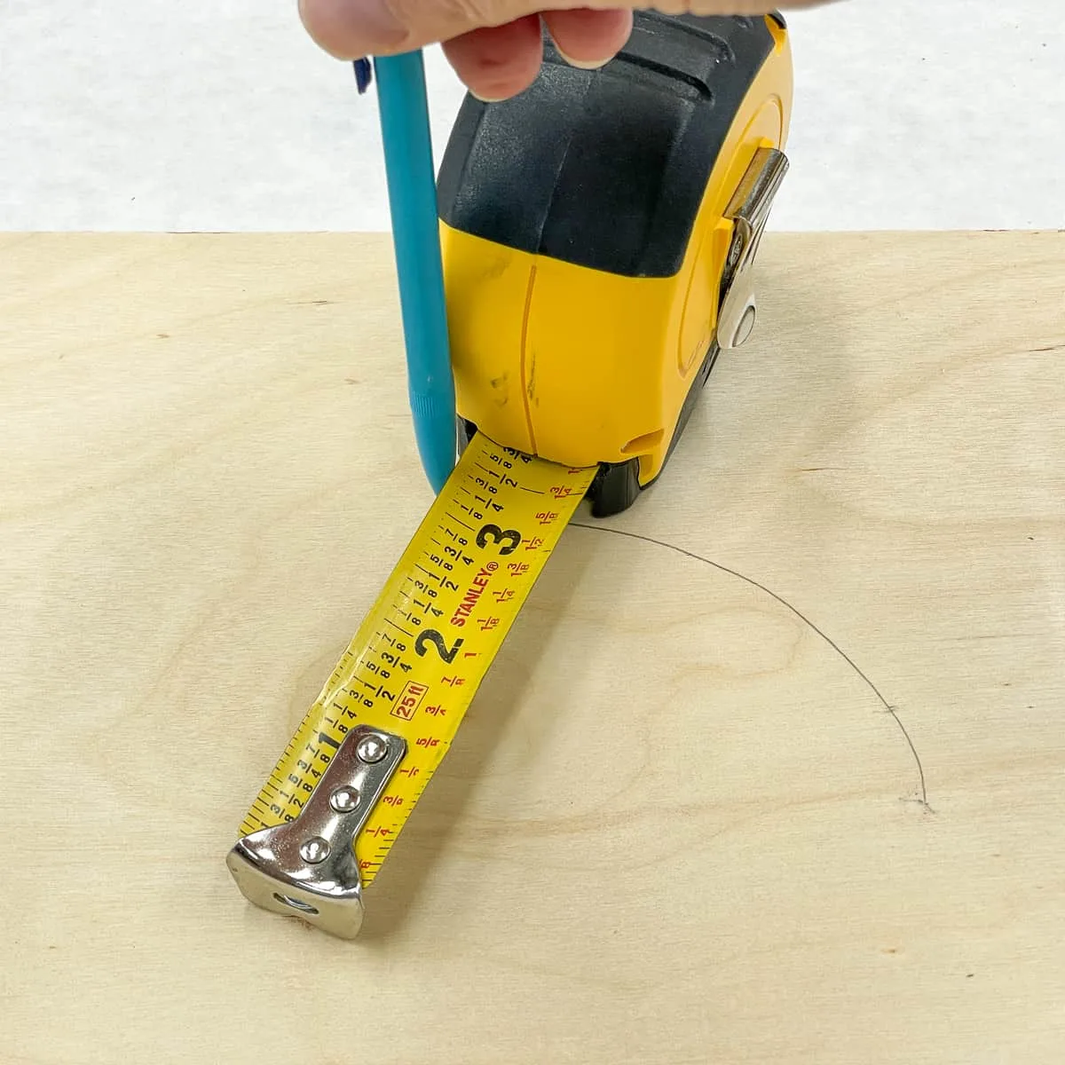 drawing a circle with a tape measure and a nail