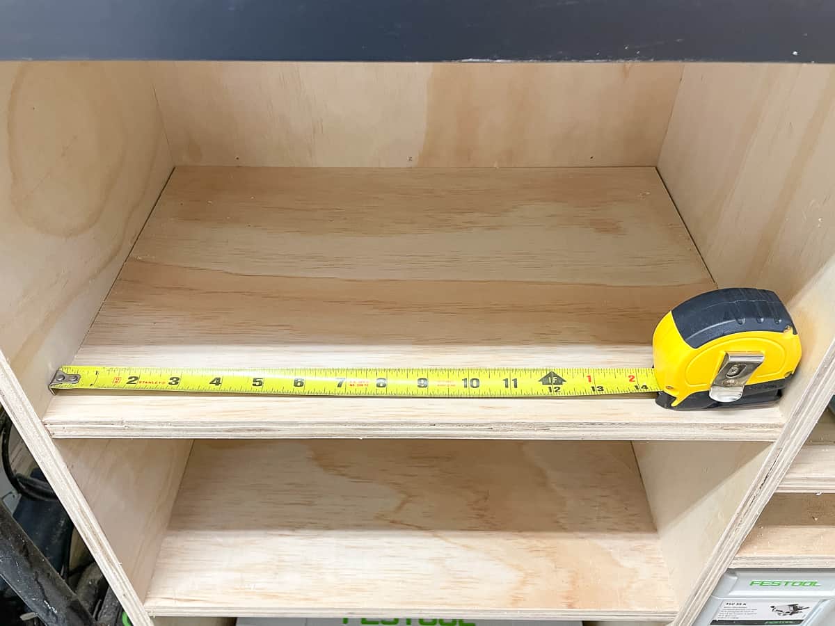 taking an interior measurement of a shelf by adding tape measurement plus housing measurement