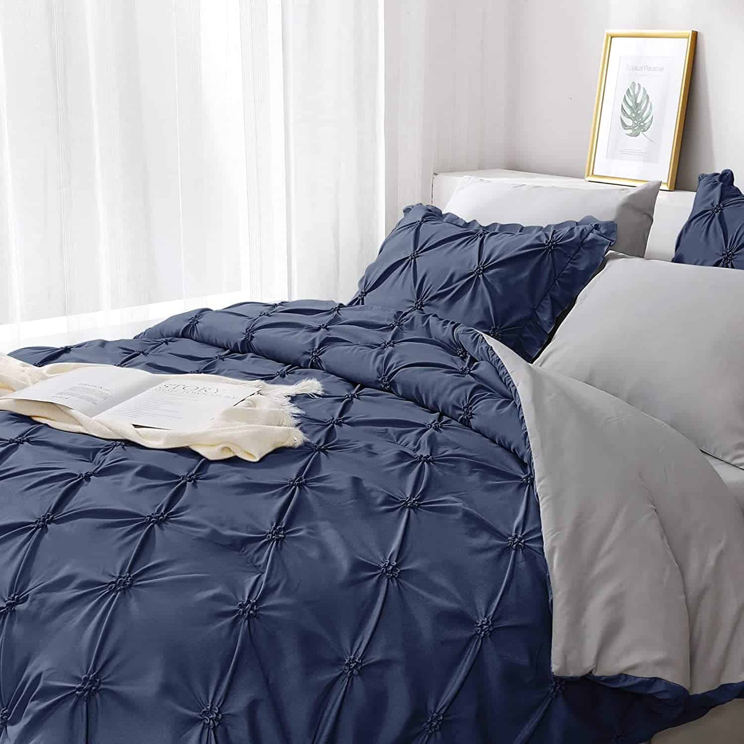 dark blue pinch pleat bedding with gray underside