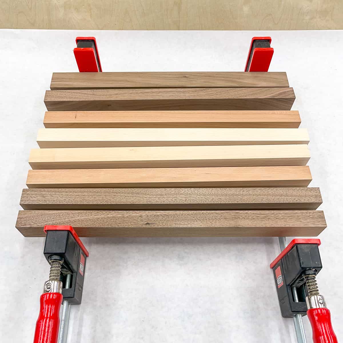 cutting board kit wood strips set on edge over two parallel clamps