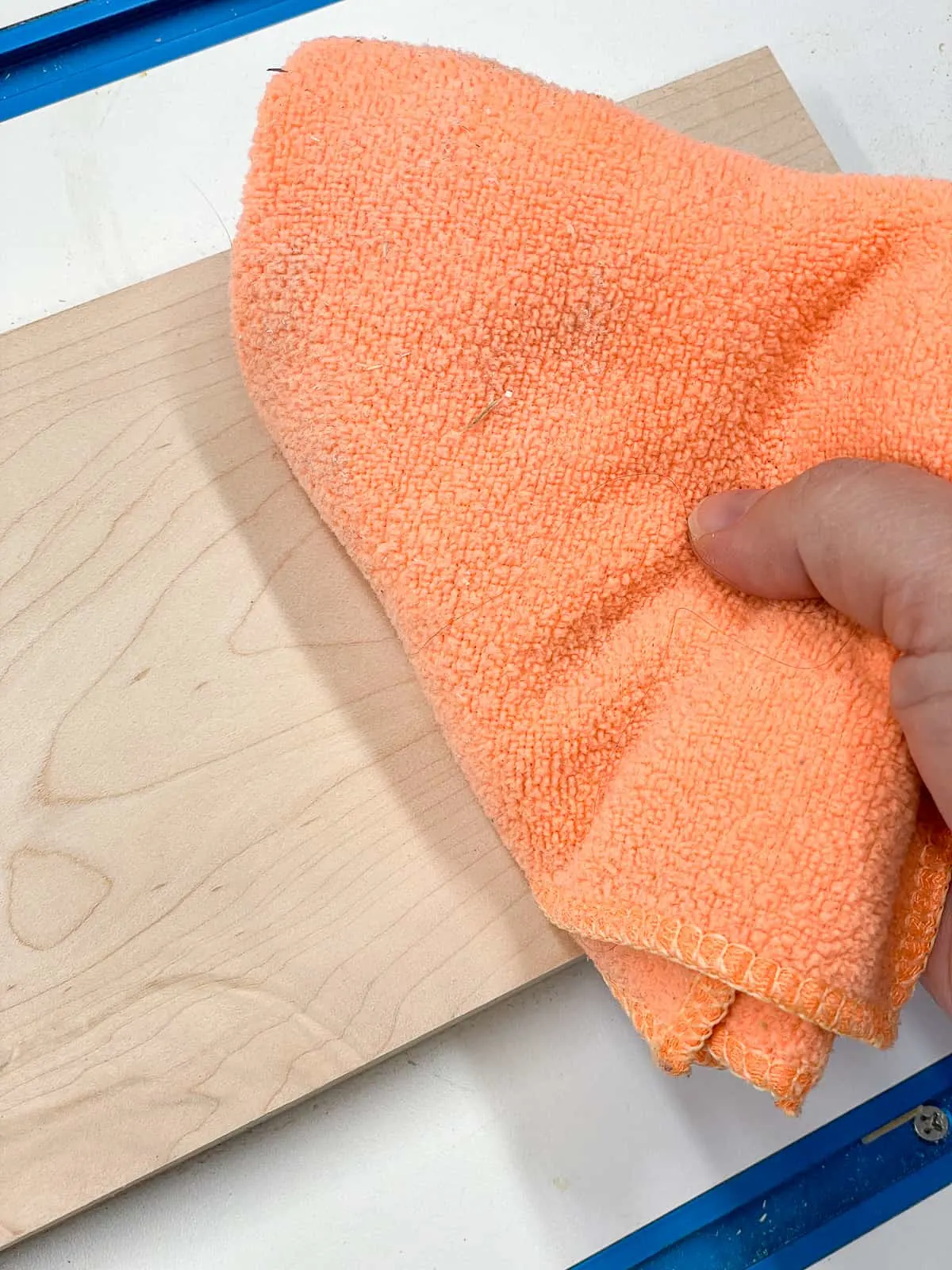 dust collected on microfiber cloth after rubbing it over a wood board