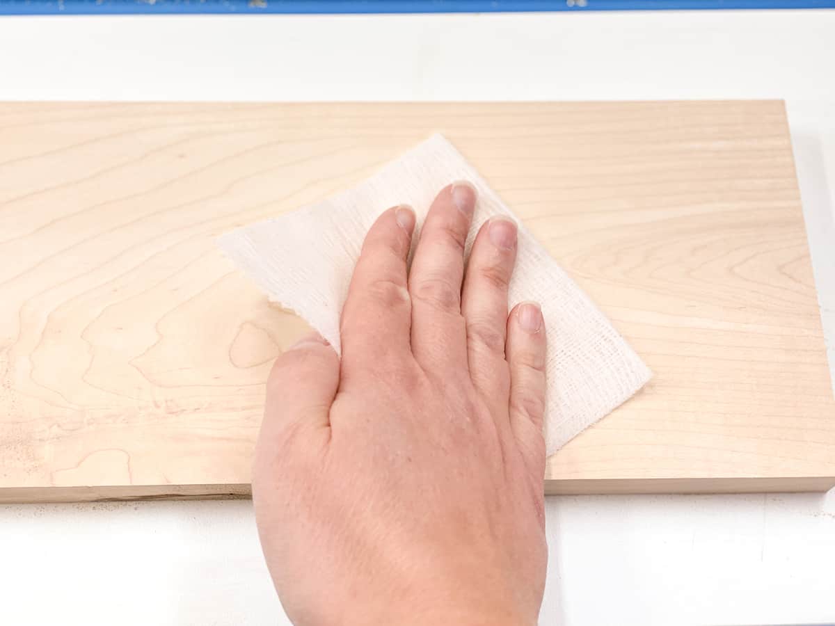 using a square of tack cloth on a maple board