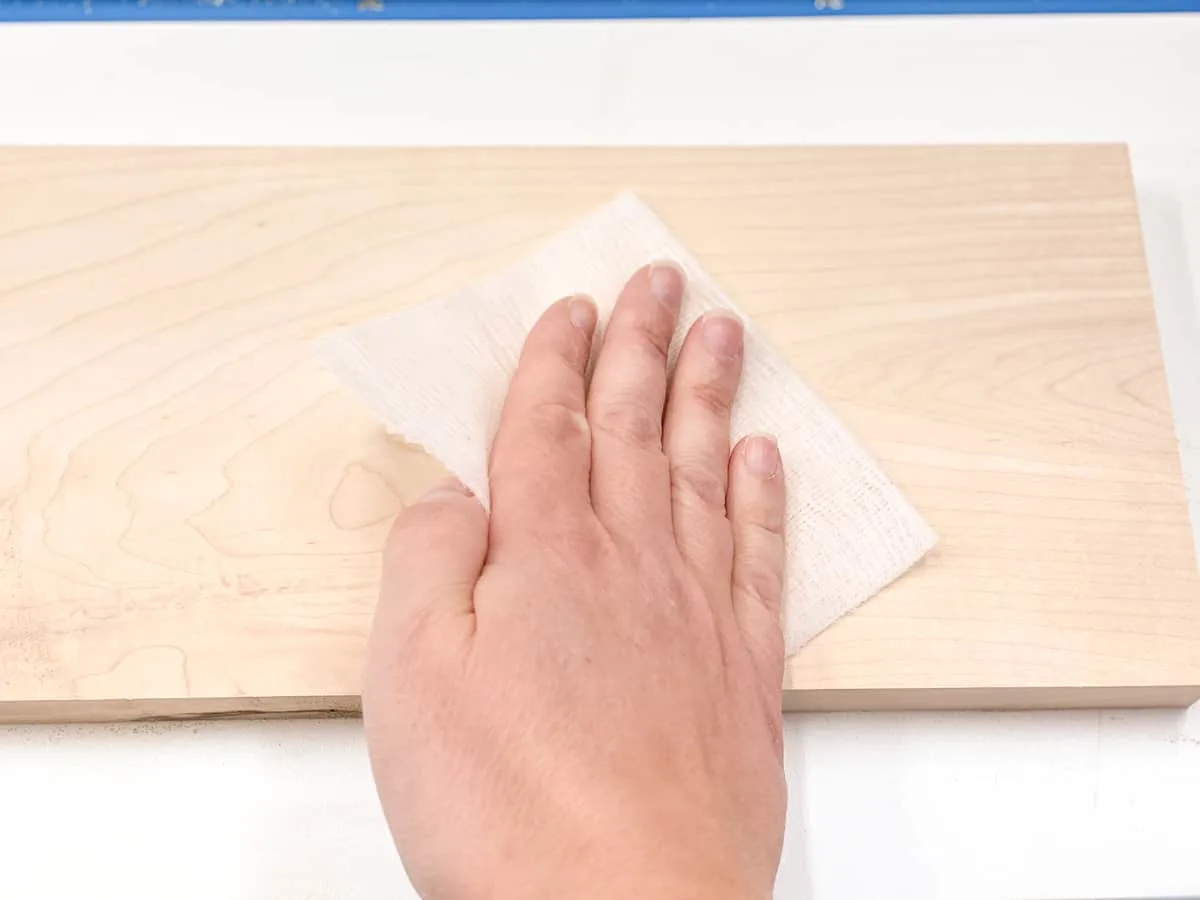 wiping plywood with a tack cloth