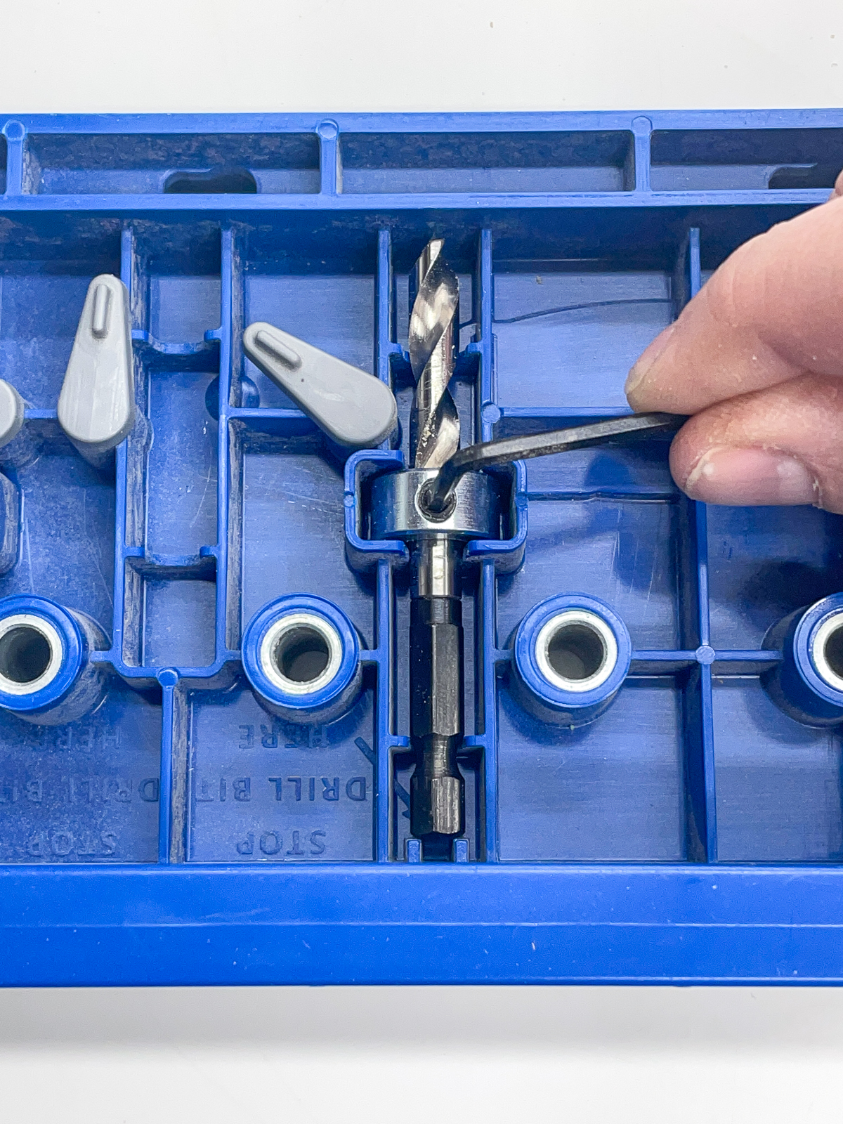 setting the depth on a drill bit for shelf pin holes on the back of the kreg shelf pin hole jig