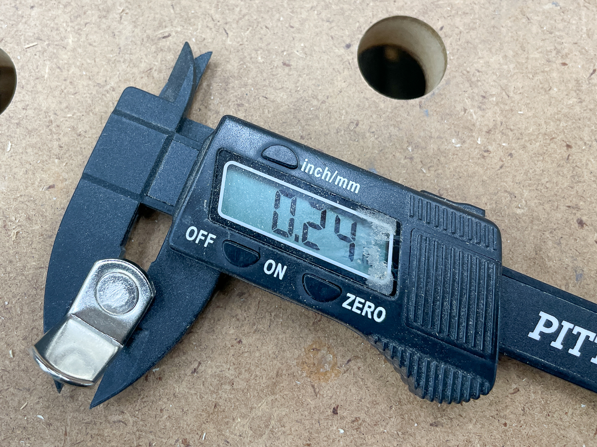 using calipers to measure diameter of a shelf pin