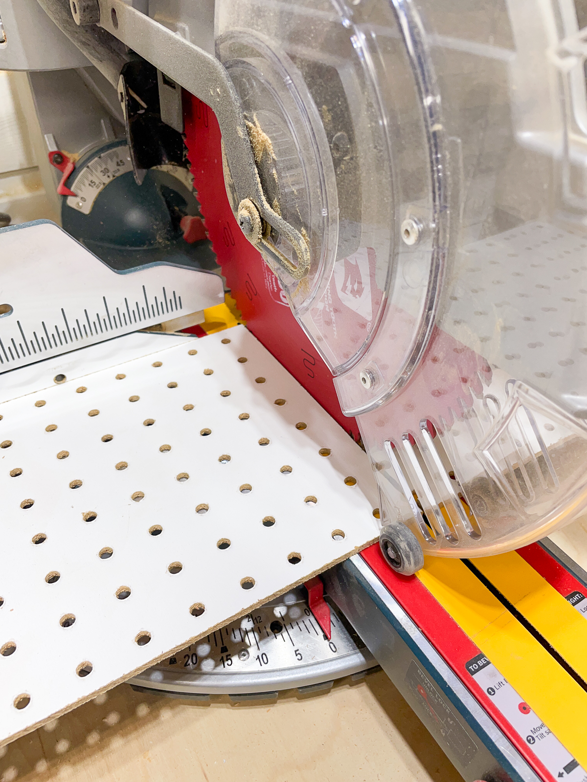 cutting pegboard for a DIY shelf pin jig at the miter saw