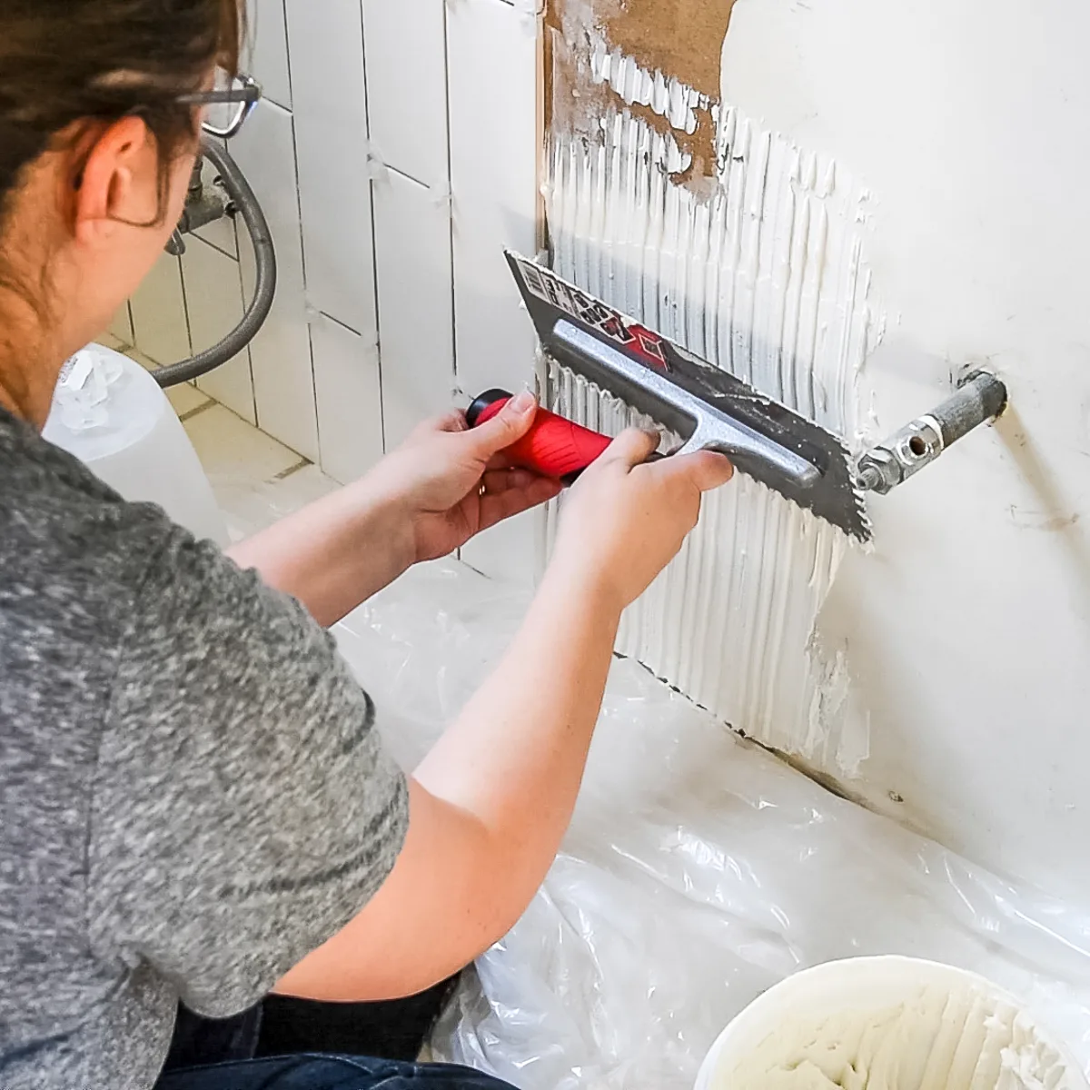 applying tile adhesive with a notched trowel